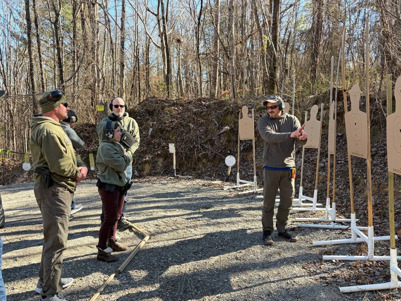 Kraken Combatives instructor coaching a group during defensive firearms training.
