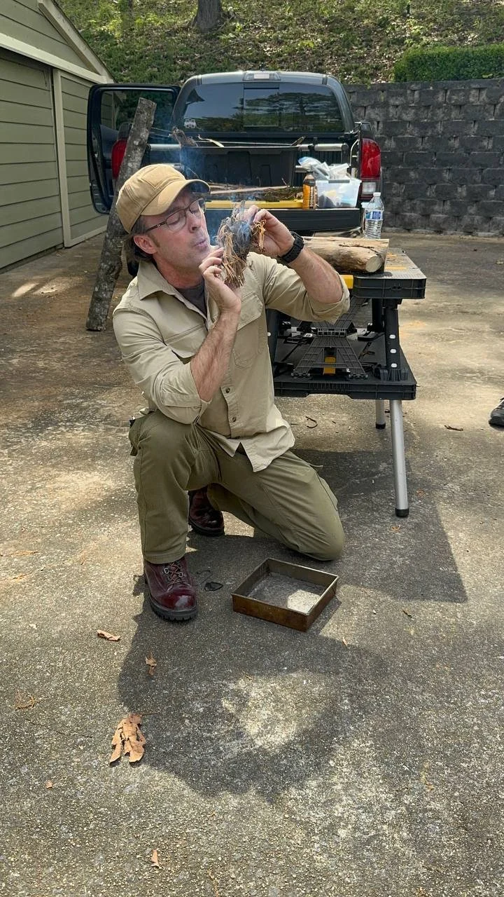Kraken Combatives instructor demonstrating fire-starting fieldcraft.
