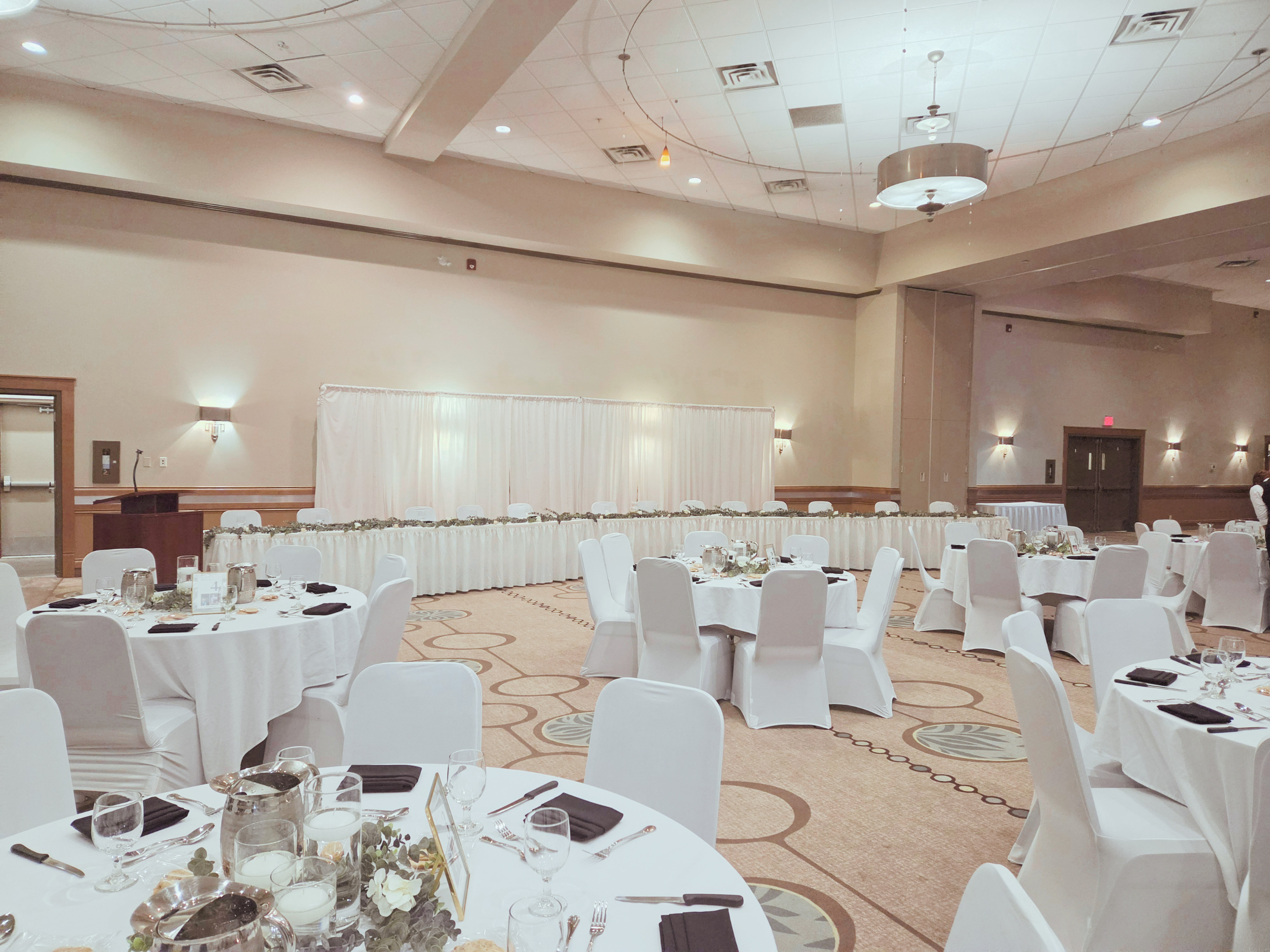Regal Ballroom set up with tables, chairs and white linens for a smaller wedding