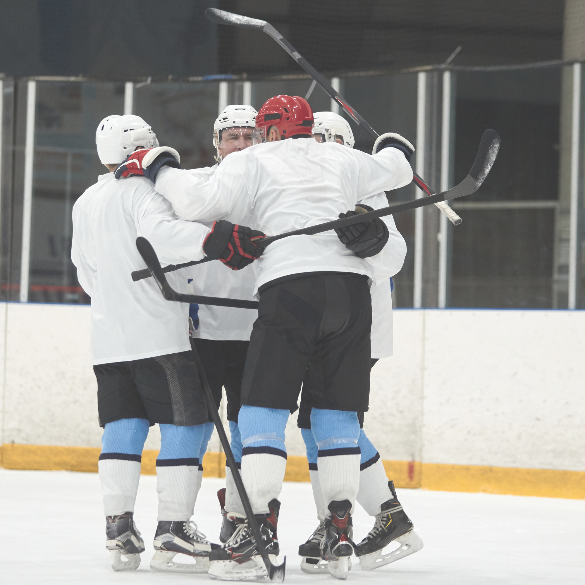 Hockey team in a group hug after a goal