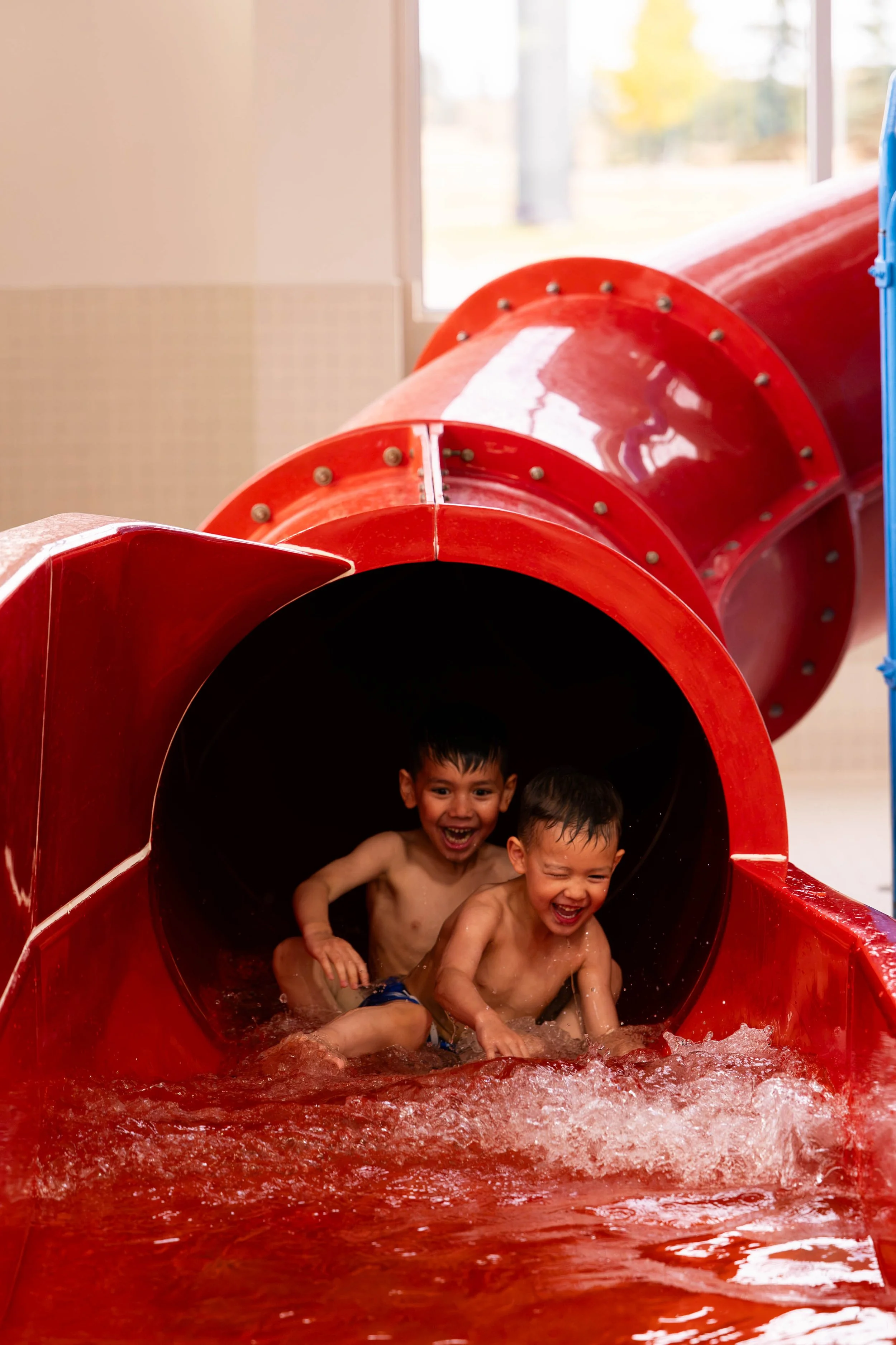 boys having fun going down the onsite waterslide