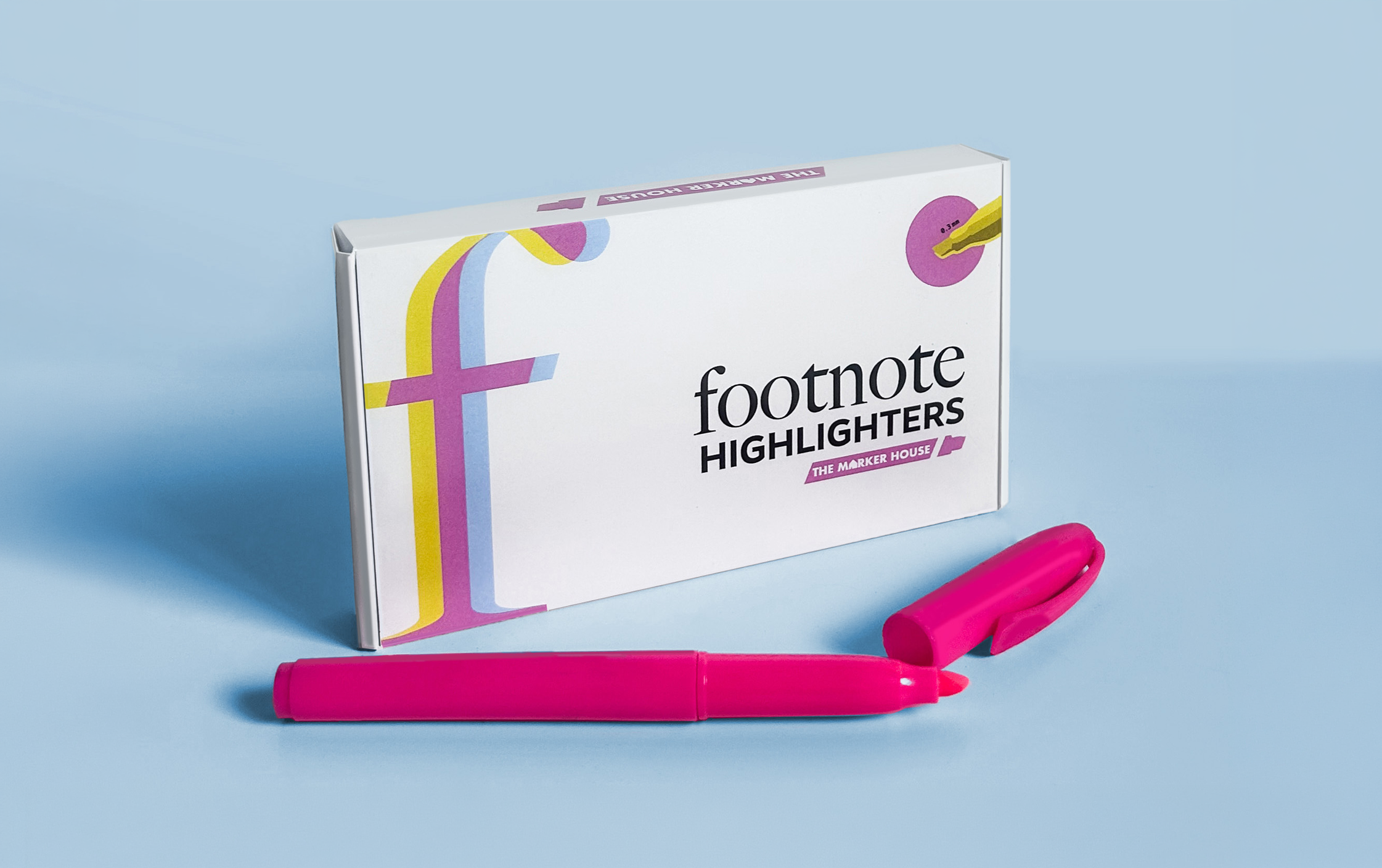 A white box labeled 'Footnote Highlighters' from The Marker House with pink and yellow highlighters and a pink marker pen in front, set against a blue background.