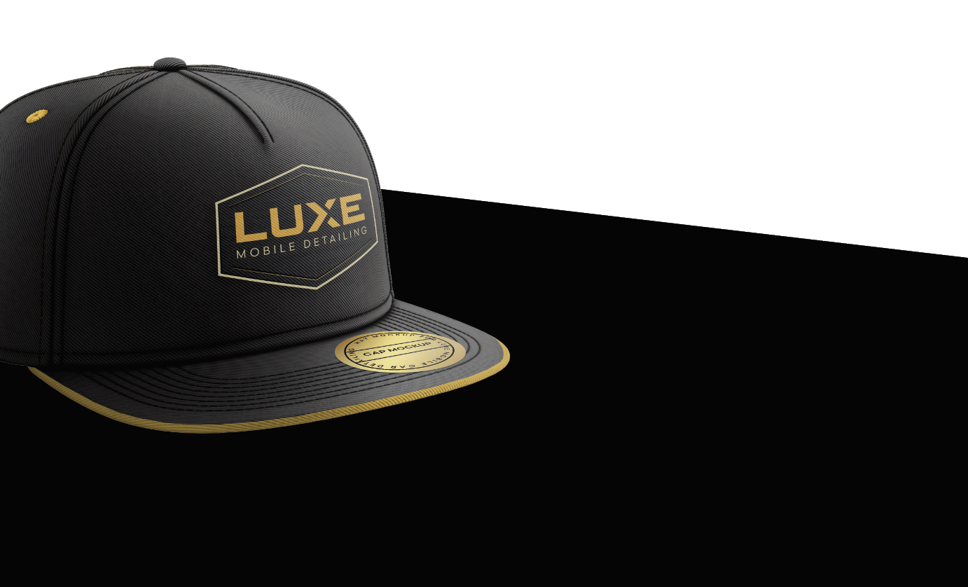 A black and gold snapback hat with the words 'LUXE Mobile Detailing' on the front, placed on a black and white background.