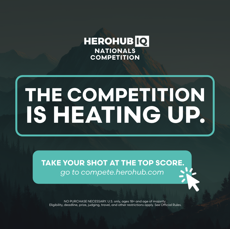 Promotion for the HeroHub IQ Nationals Competition with mountain background and text 'The competition is heating up' and instructions to take a shot at the top score.