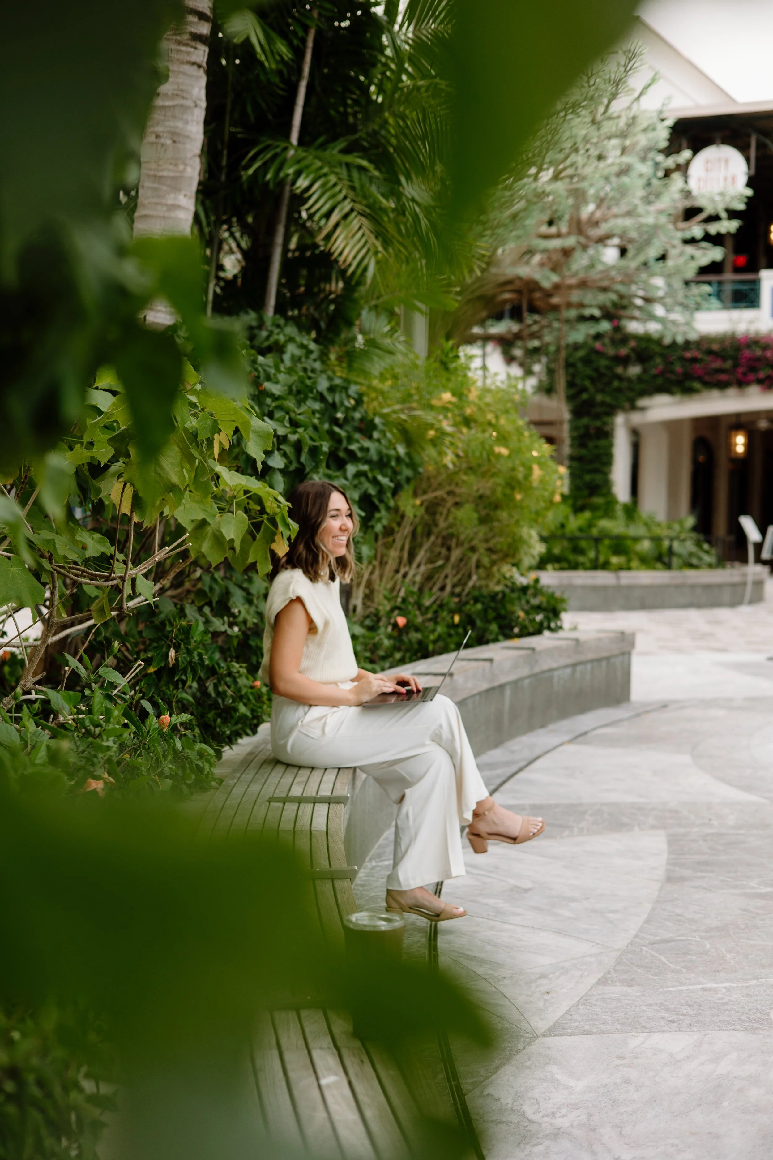 Kailyn España, counselor, working on her laptop outdoors