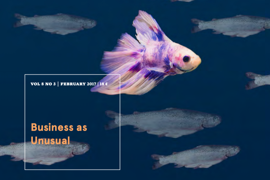 Magazine cover titled 'Business as Unusual' with a colorful betta fish swimming among other fish against a dark blue background.