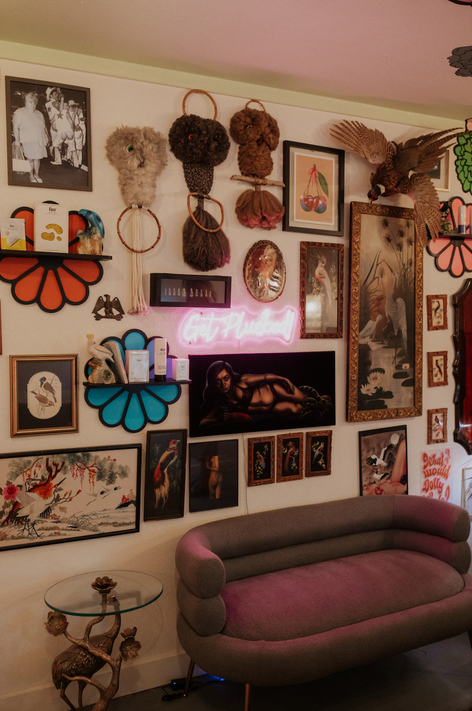 Eclectic waxing studio interior with vintage artwork, product displays, and lounge seating