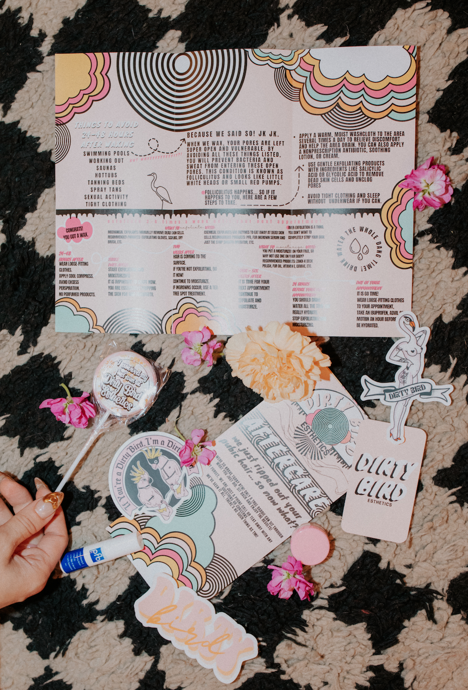 Waxing aftercare instructions and branded client materials displayed with skincare essentials