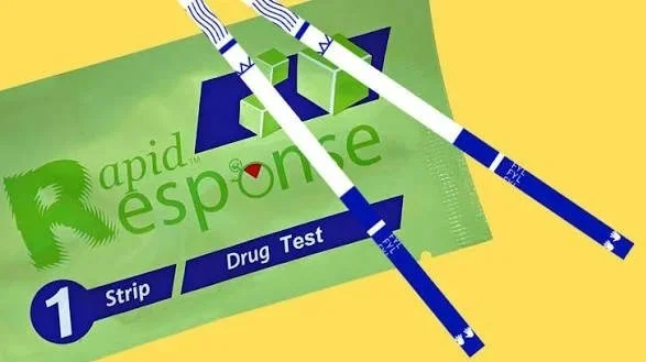 A rapid drug test kit with multiple test strips on a green background.