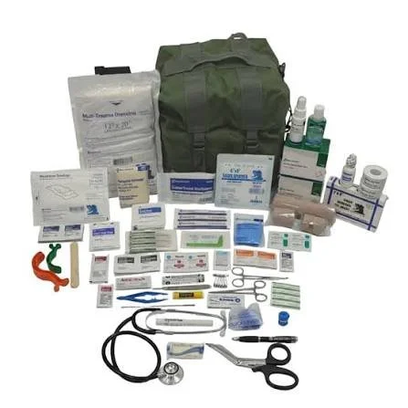 A collection of medical supplies including bandages, syringes, bottles, scissors, a stethoscope, and a green medical bag.
