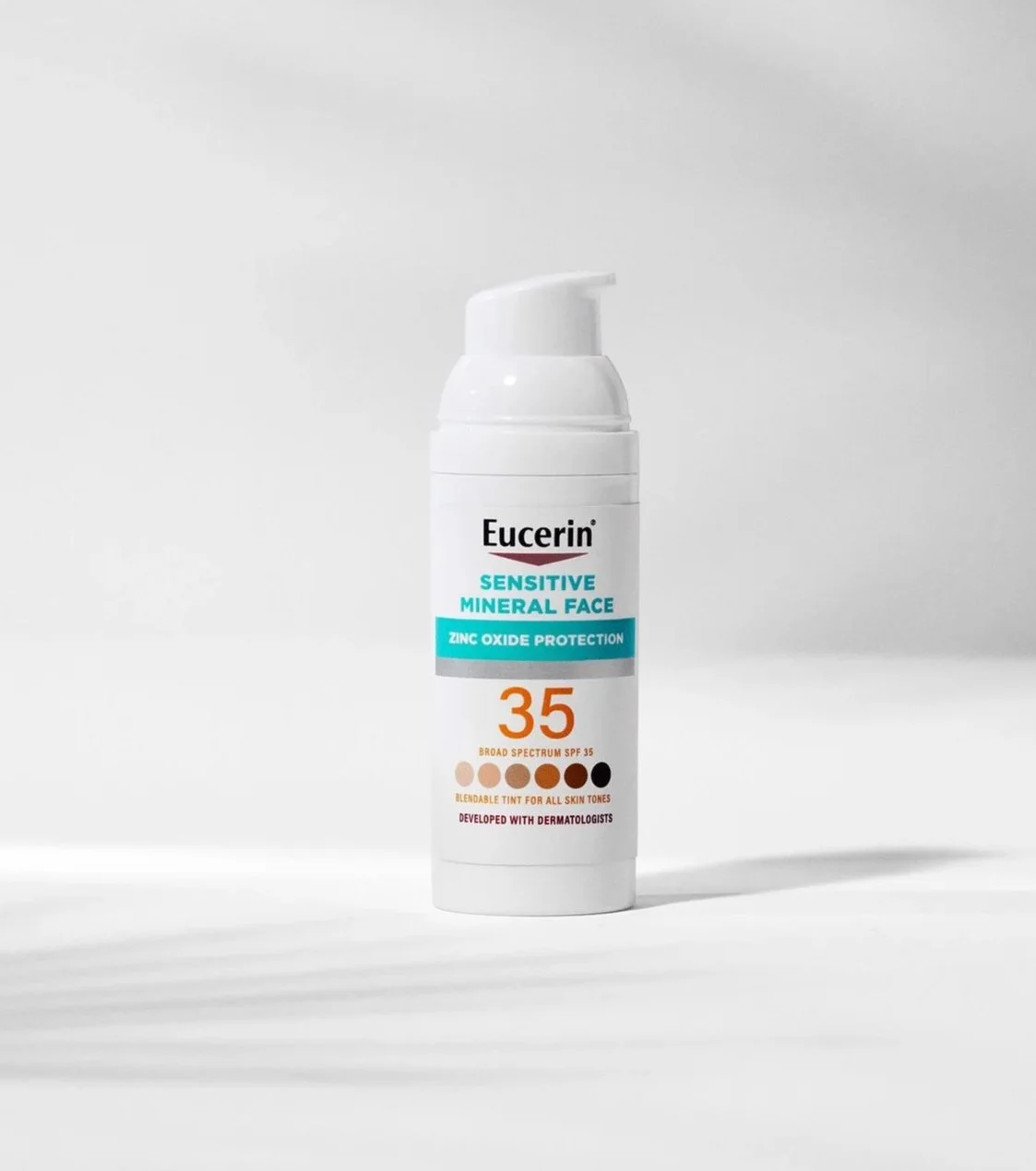 A white bottle of Eucerin Sensitive Mineral Face sunscreen with SPF 35, featuring a pump dispenser, set against a white background.