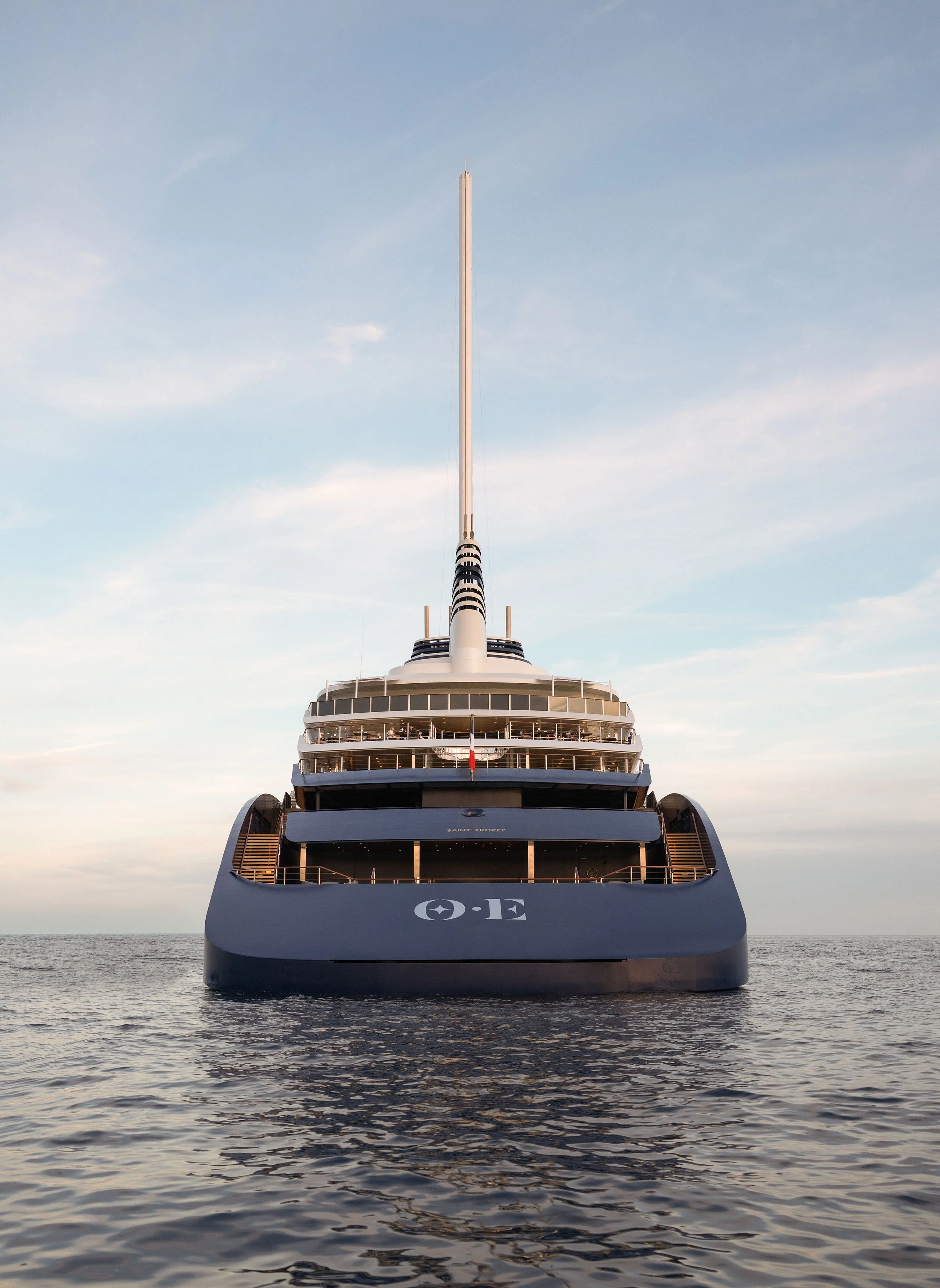 The Orient Express Corinthian , Suite Panoramique boat, floating on calm water with a clear sky background.