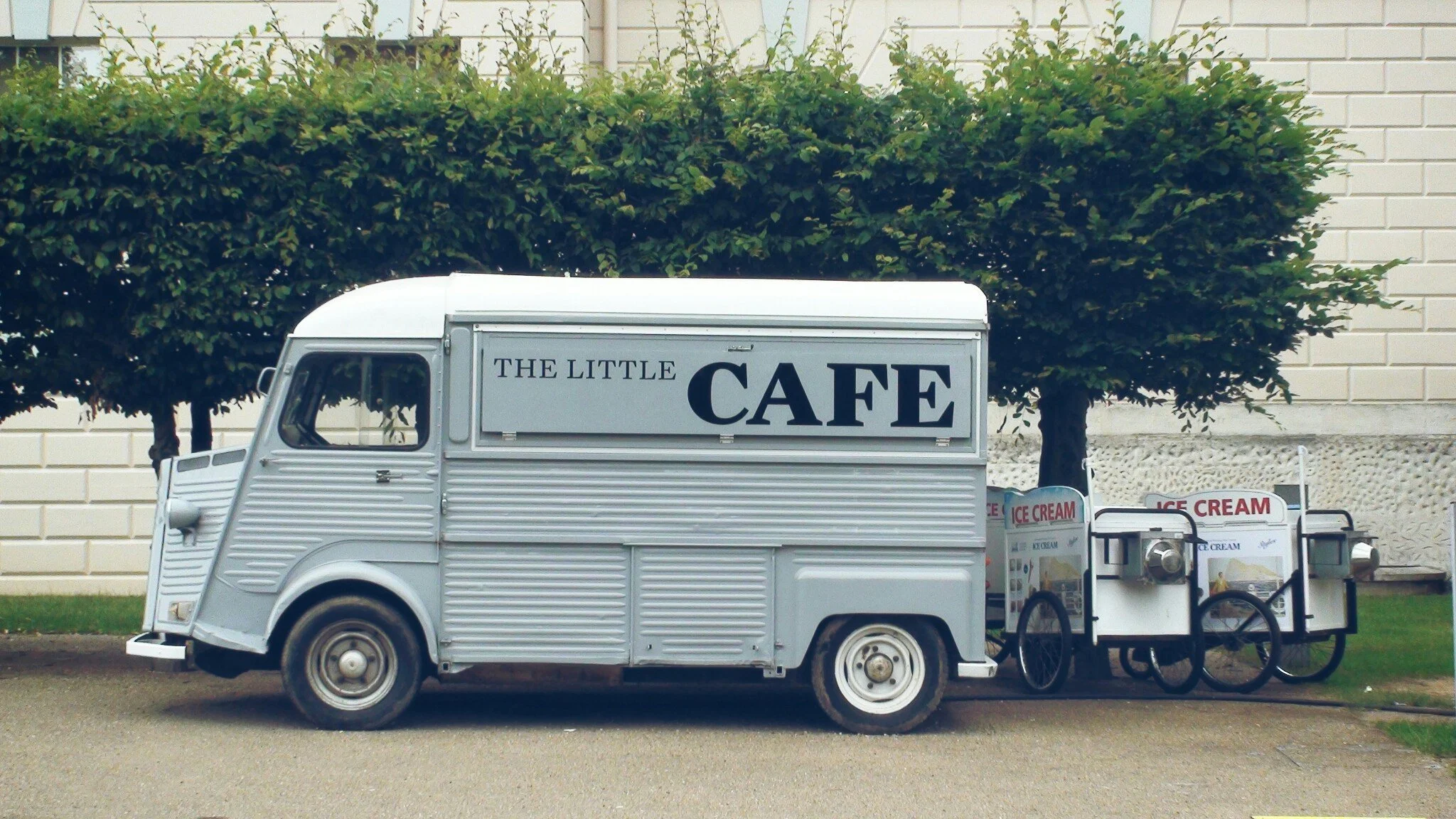 Mobile coffee cart owner preparing espresso drinks at an outdoor event.