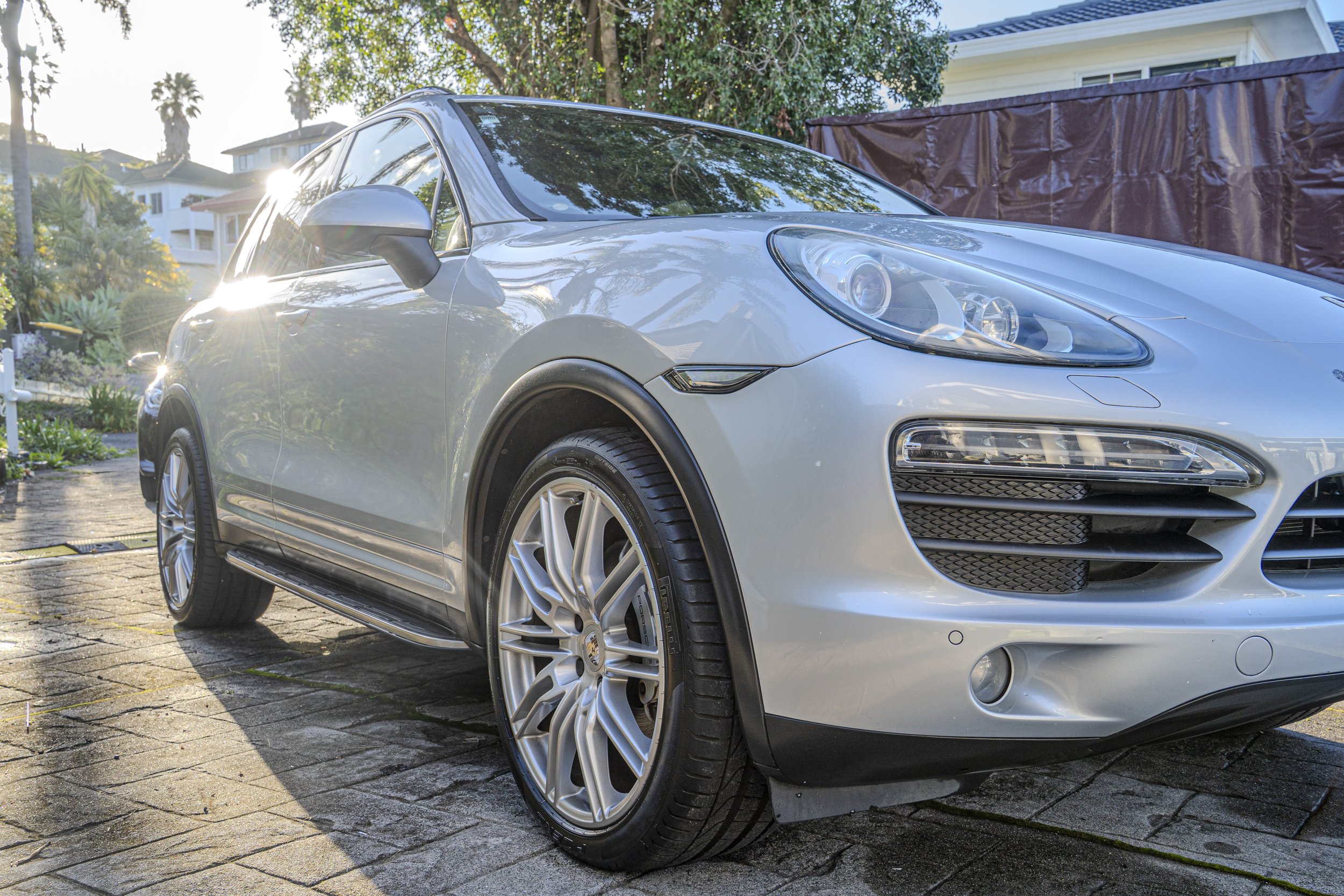 glossy paint of a porsche cayman S after a detail from the front