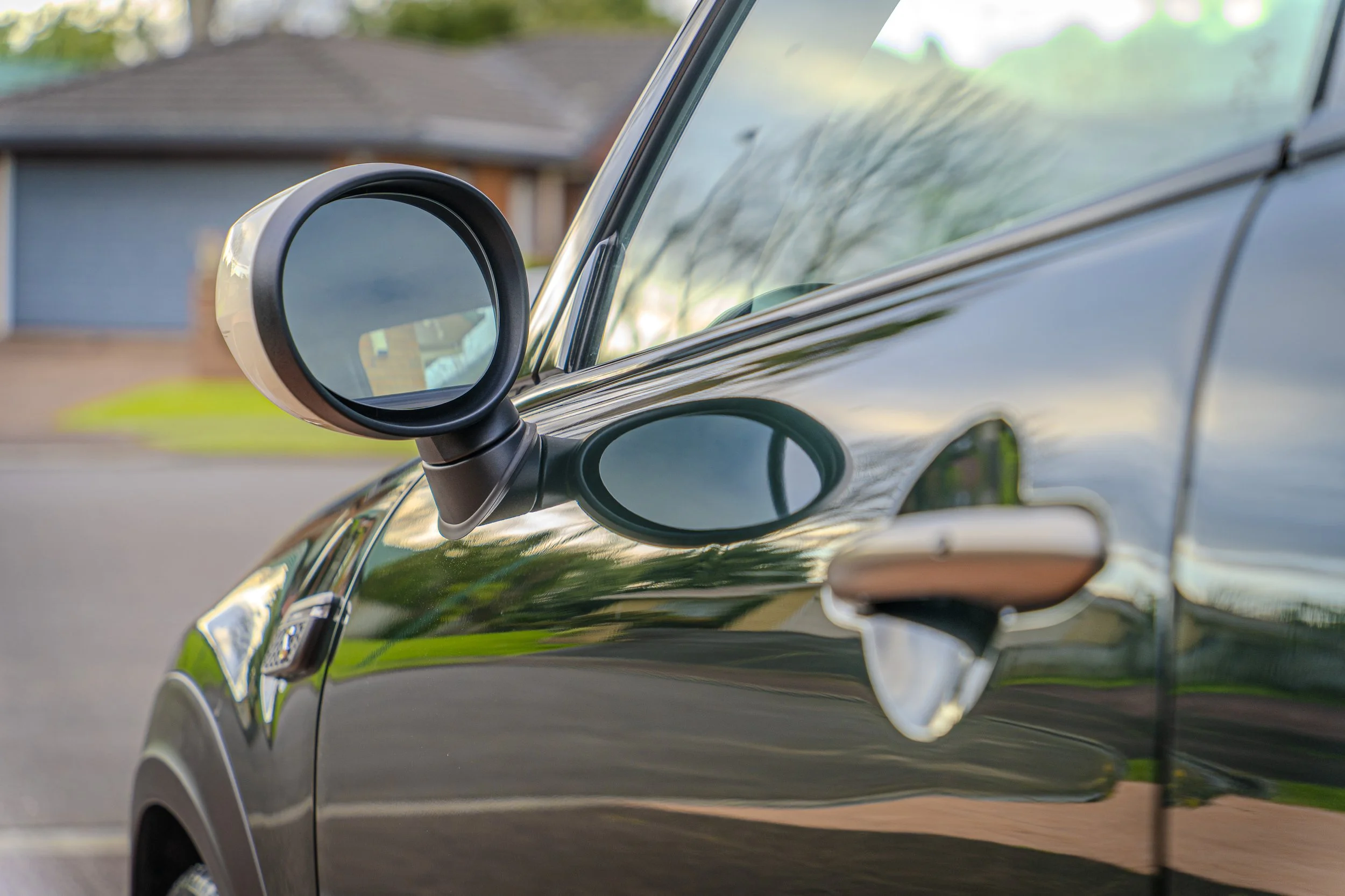 glossy paint of the british green mini cooper s EV