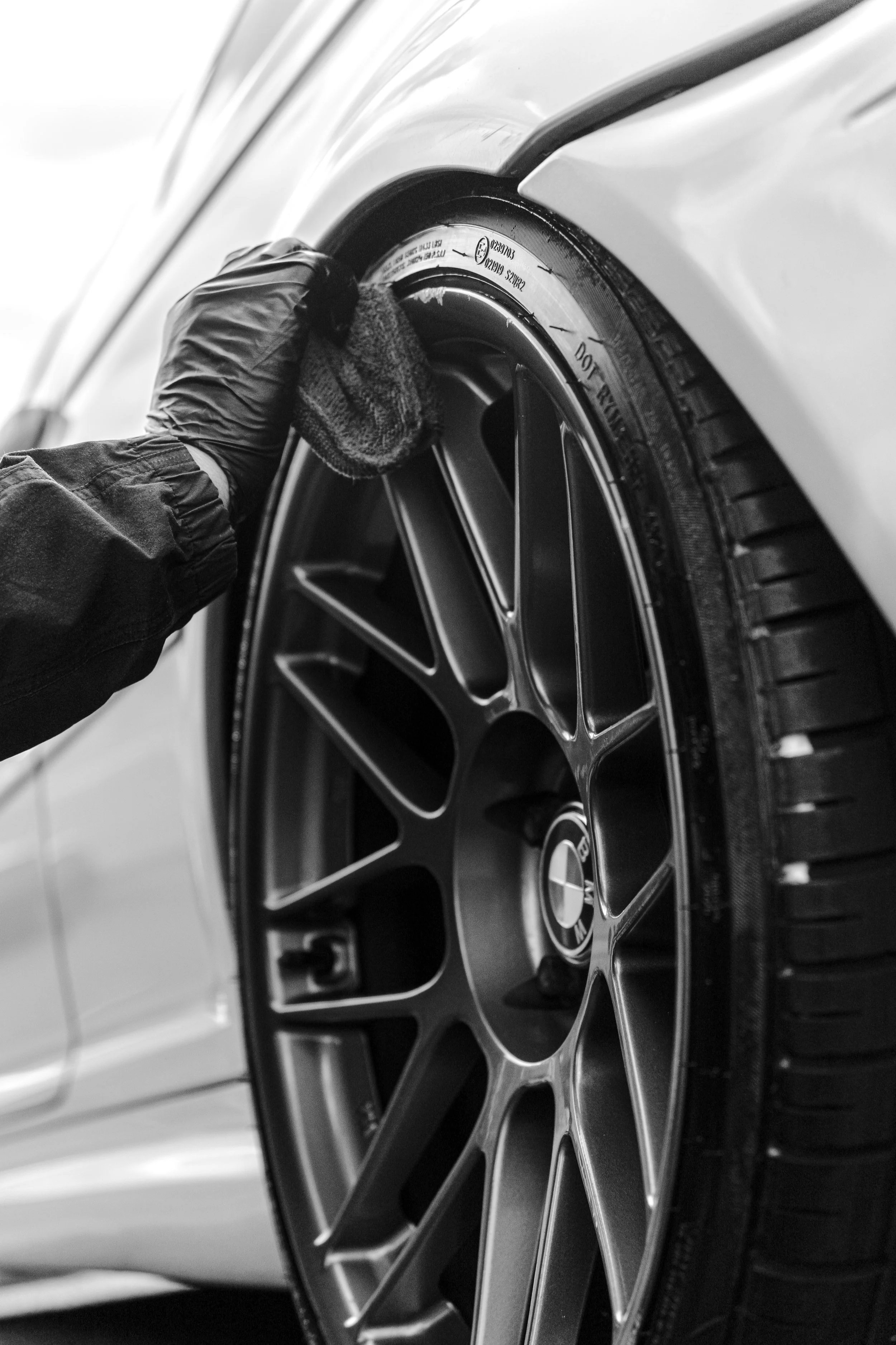 detailer wiping down the tyres after a detail