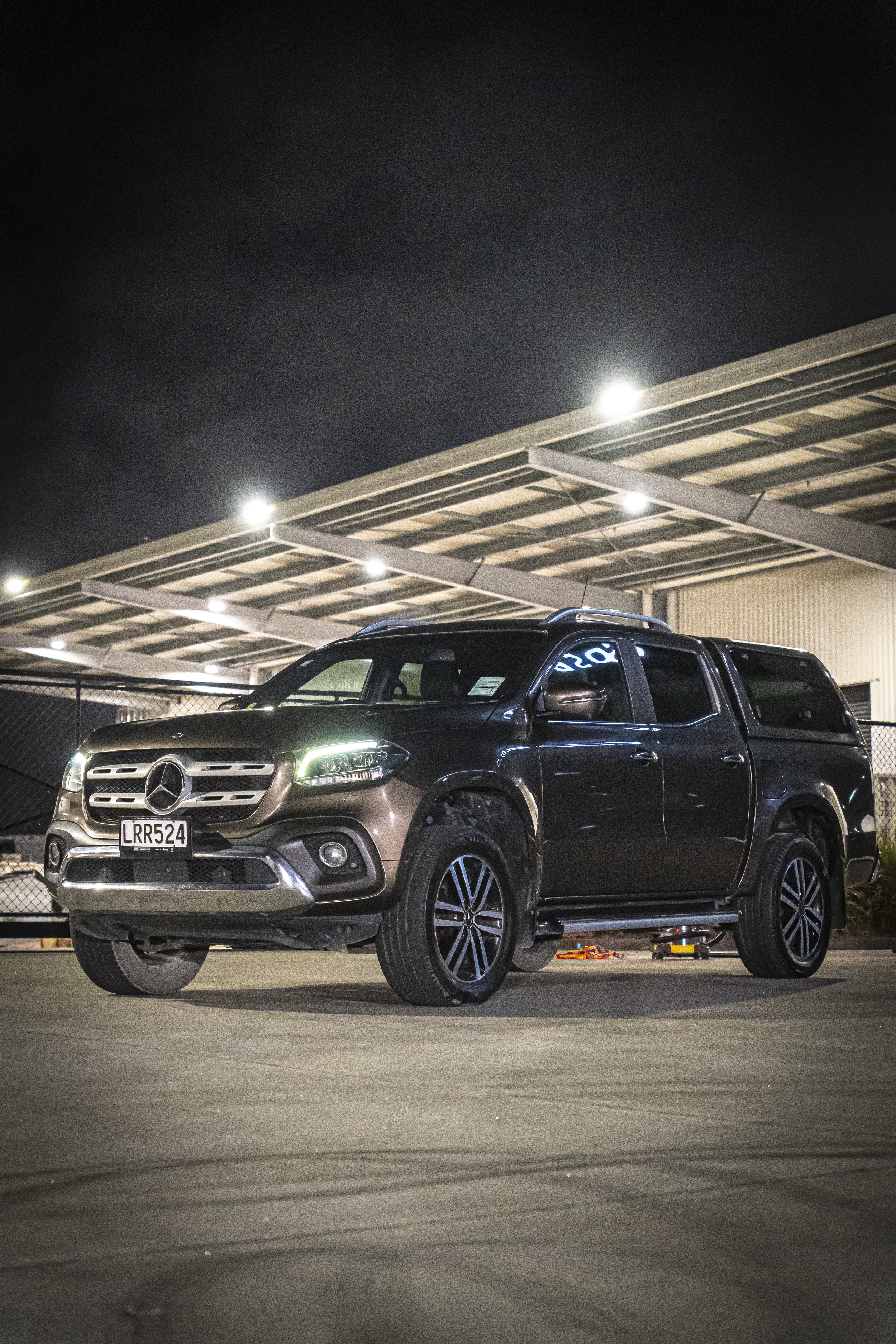 front view of a mercedes after a detail at night