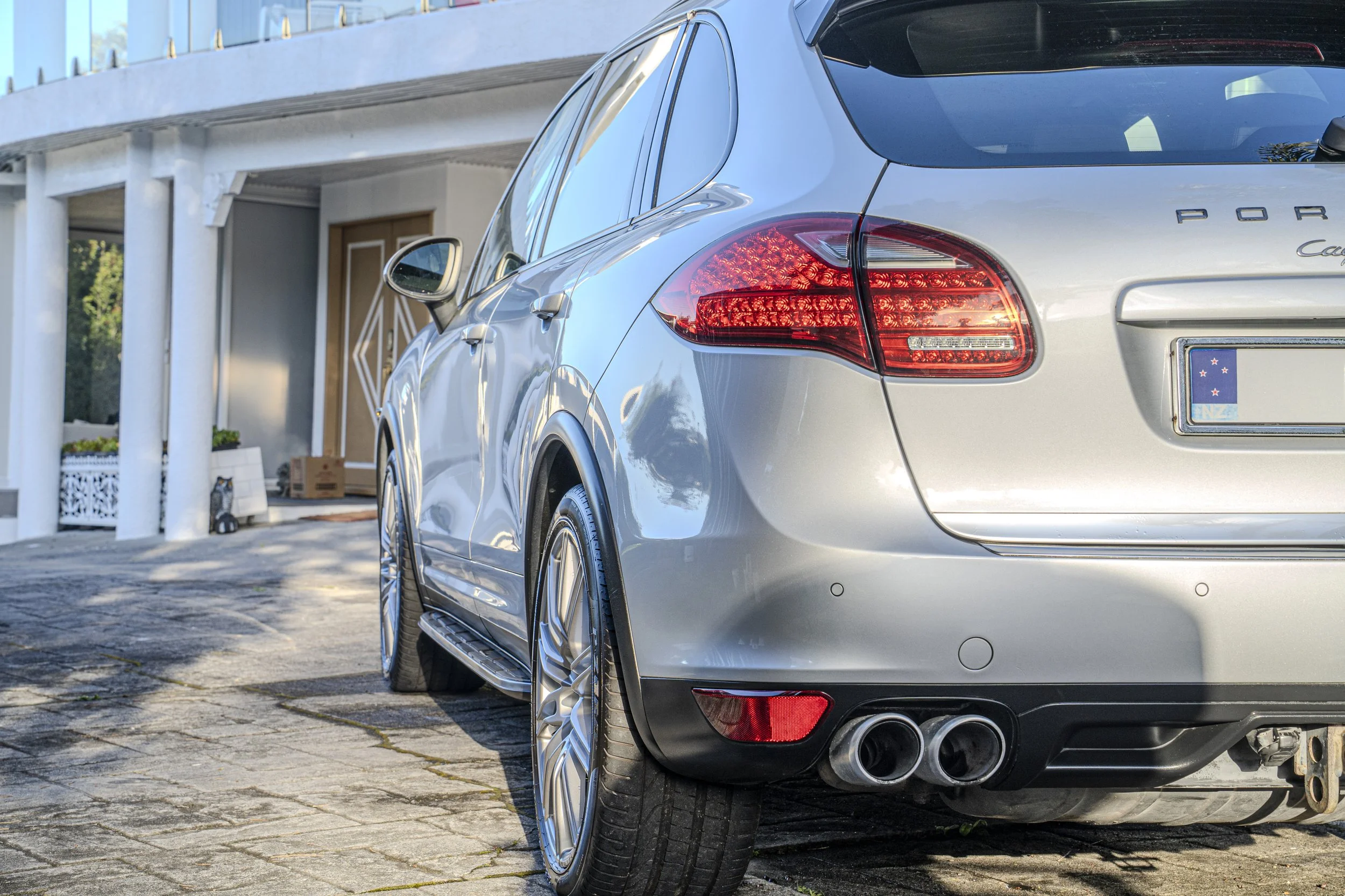 a side view of a porsche cayman s after a detail