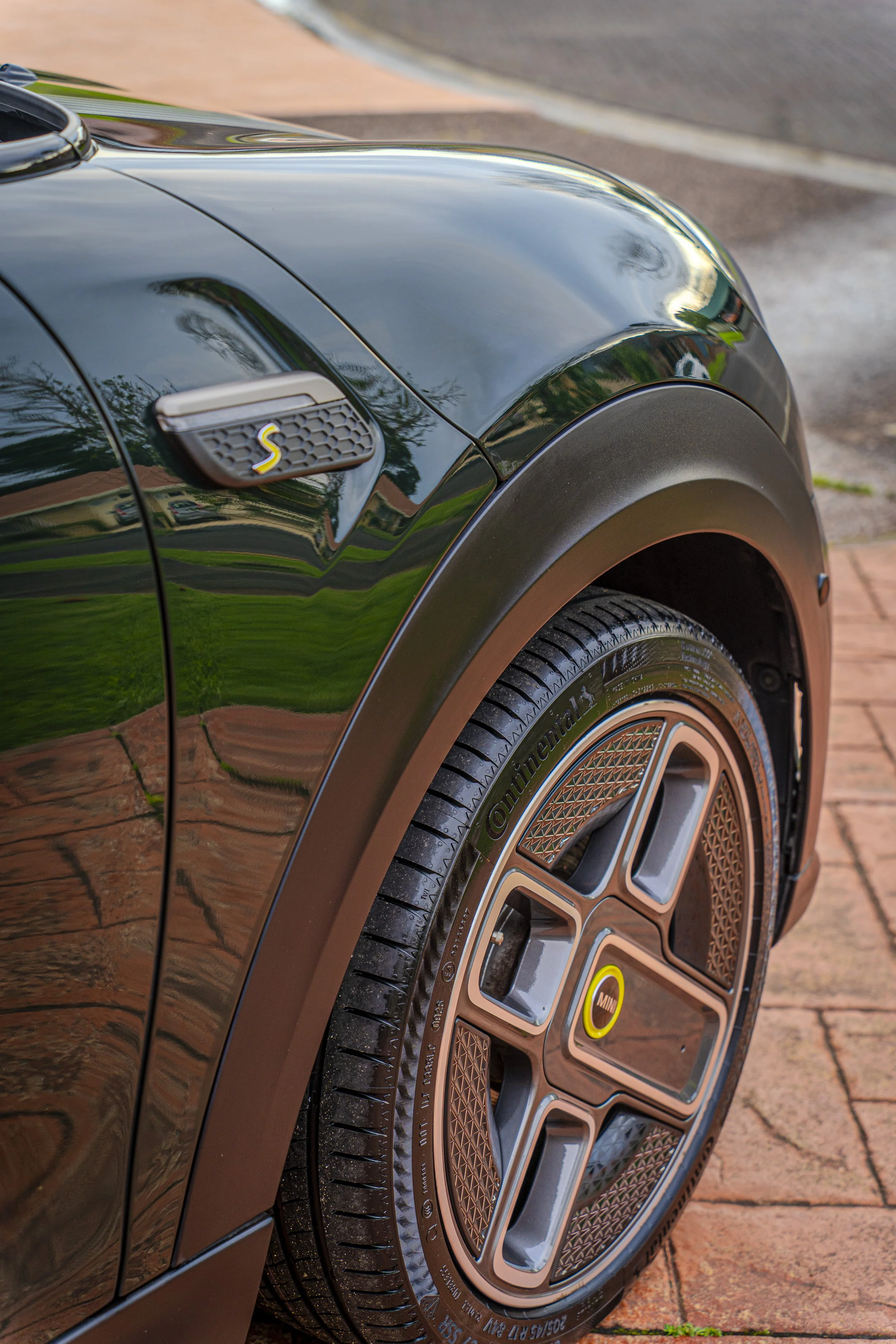 a slick wheel that's been detailed with the mini cooper s badge