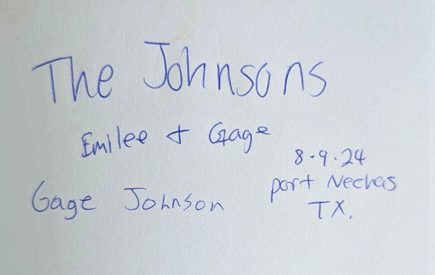 Handwritten note on white paper with blue ink, titled "The Johnsons" with the names Emlee and Gage, dated 8.9.24, with location Port Neches, TX.