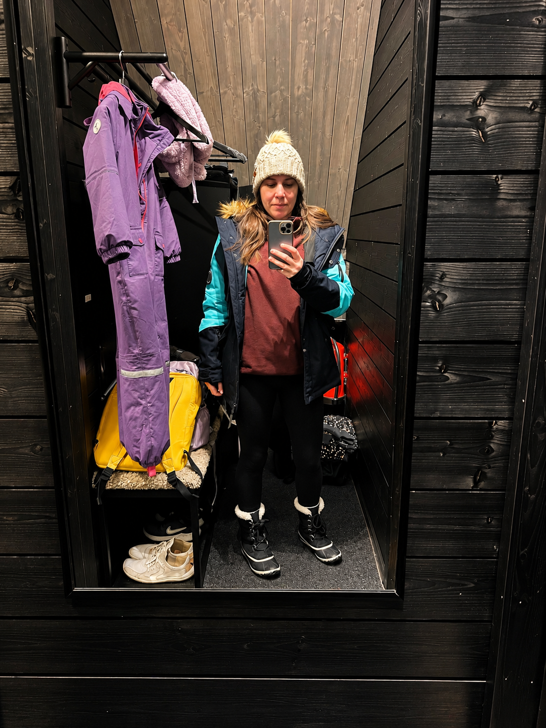 Winter Mirror Selfie in a Wood-Paneled Changing Room.png