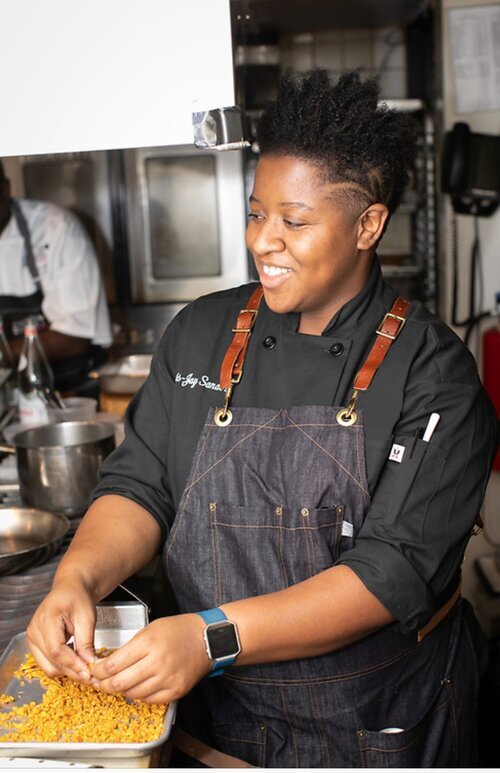 Mavis-Jay Sanders began mastering southern cooking before she could even see over the counter. Legend has it, she perfected poundcake before her abc’s. Looking to cultivate her talent, Mavis-Jay attended the Culinary Institute of America after receiving a BS in hotel and restaurant management from Georgia Southern University. Later, she would impress with her ability and natural leadership at Blue Hill at Stone Barns, Blue Hill, and Untitled in New York. She went on to be part owner of the award winning food truck Pico House in Los Angeles. Frustrated witnessing good food as a luxury for the rich, Mavis-Jay moved back to NYC to join the team at The Brownsville Community Culinary Center as Director of Operations to provide free, paid, world class culinary and hospitality training to marginalized communities in Brooklyn that culminated in guaranteed career placement. Most recently, she joined the team at Drive Change as Director of Culinary Development and Education.&nbsp;Mavis-Jay is a chef who believes in sustainably raised ingredients, thoughtfully prepared. She is a social equity advocate that has dedicated her career to fighting for food justice in black and low-income communities. In 2019, she was honored as one of Star Chefs’ New York Rising Star Chef.