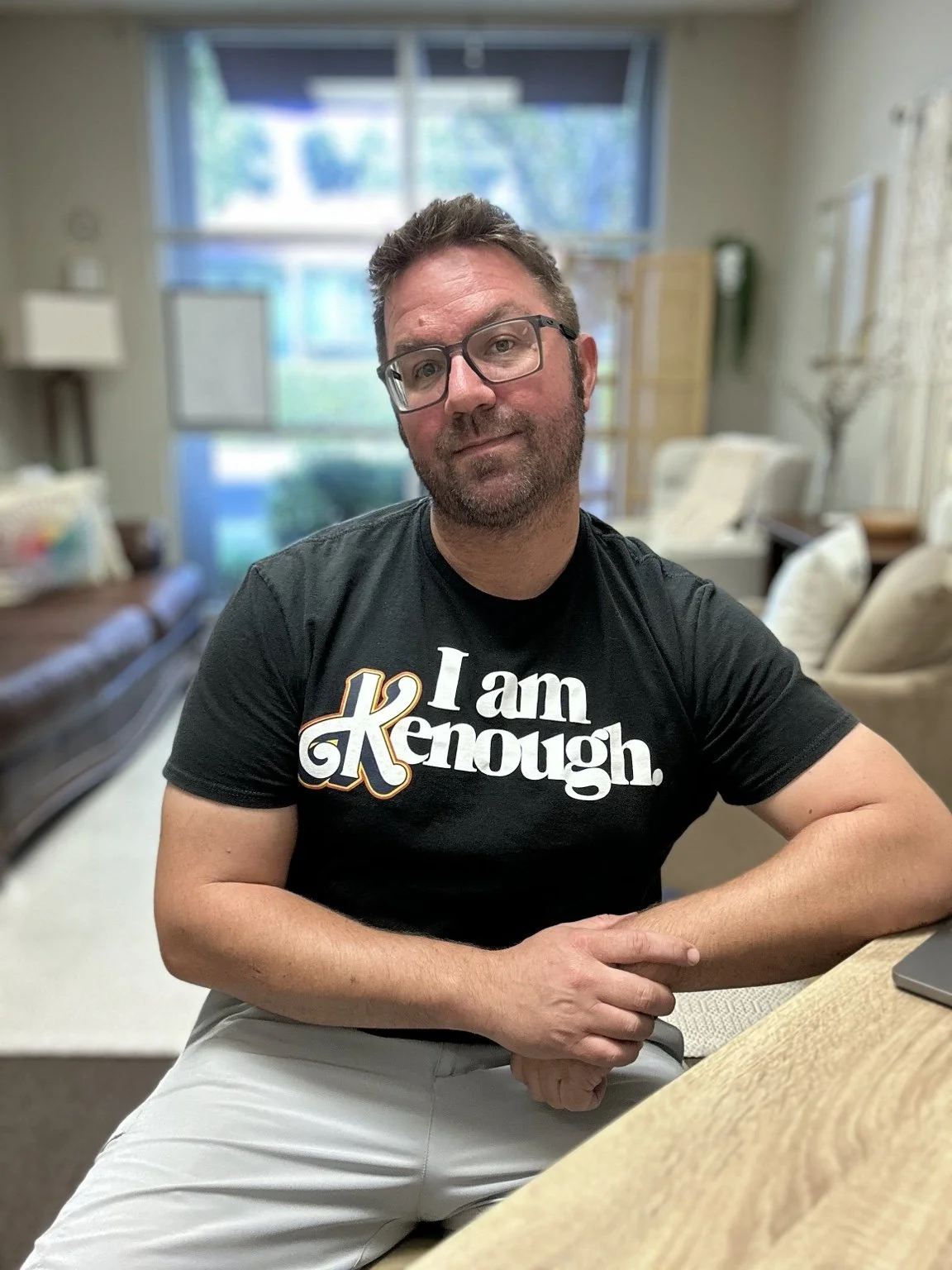 Chad Pickens seated wearing an “I am Kenough” T-shirt.
