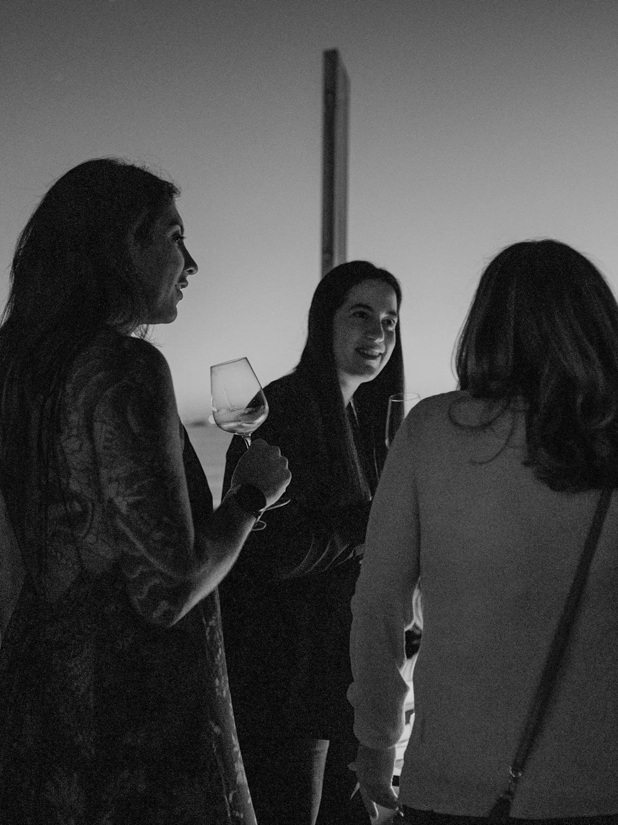 Black and white photo of three women having a conversation