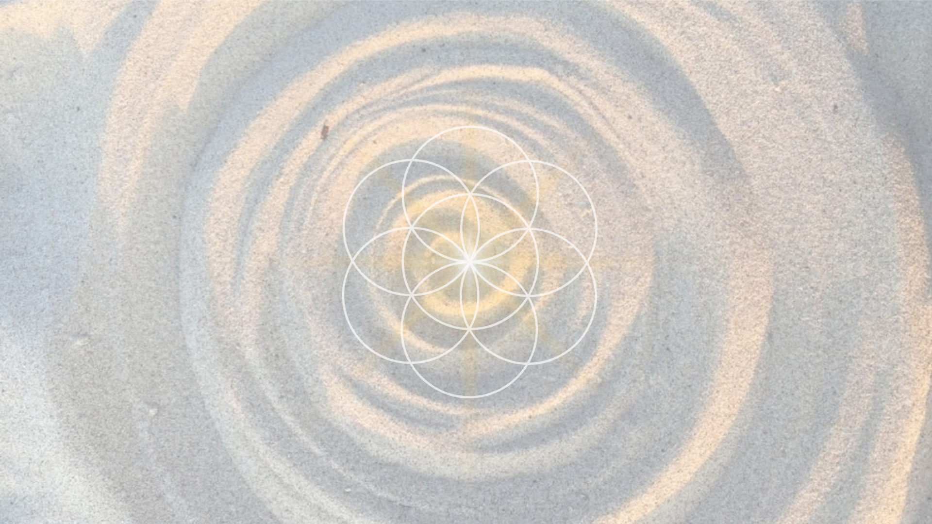 Close-up of textured sand surface with ripples and a geometric overlay of interconnected circles at the center.