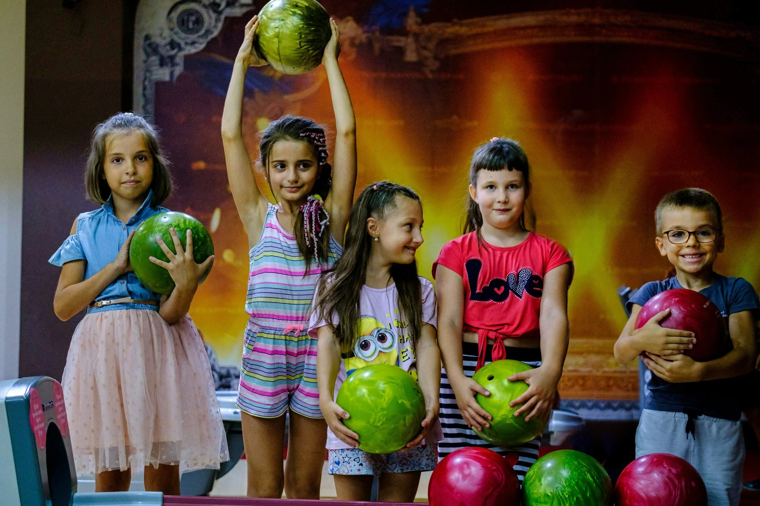 Photo of children holding bowling balls
