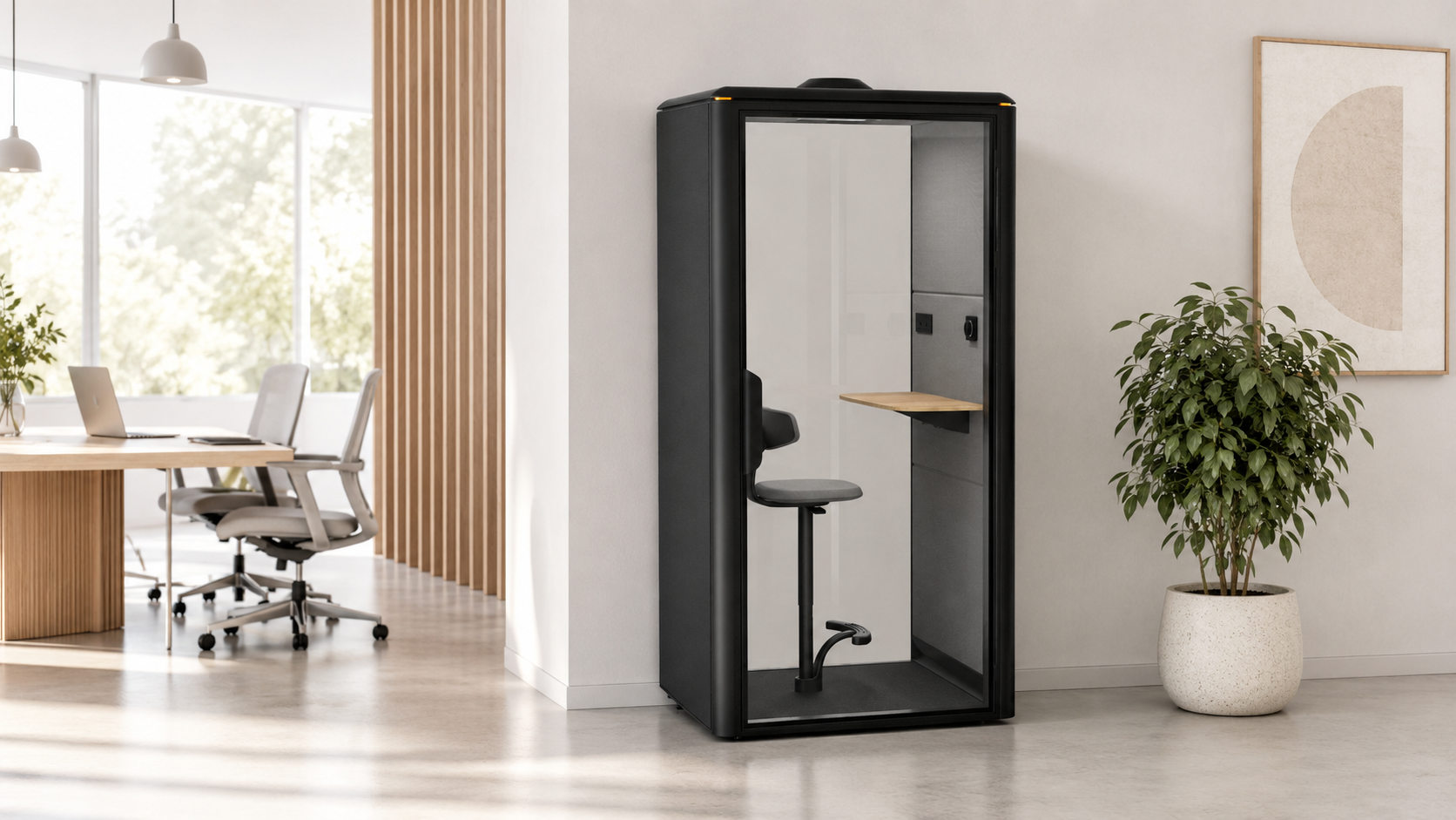 Black GoPod phone booth beside a wooden desk with laptop in a modern Victoria office with natural light
