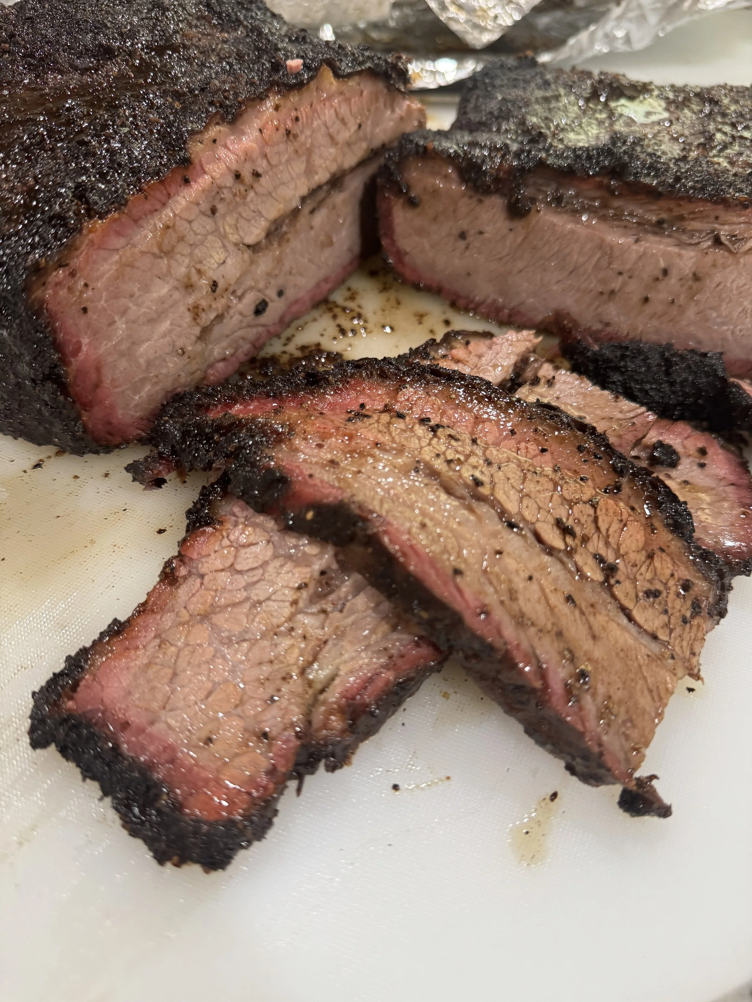 Prime Brisket Seasoned with our in house blend and smoked to the bark is irresistible and the protein melts in your mouth,