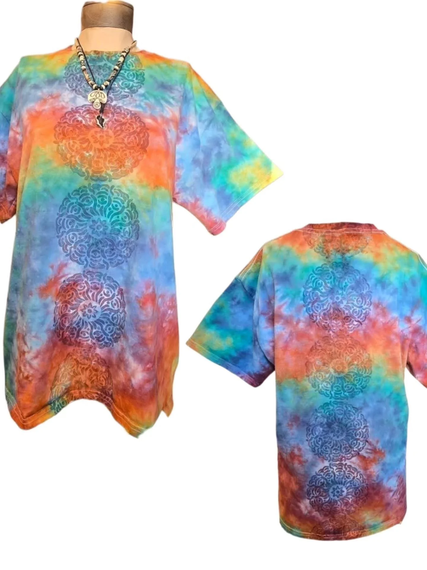 A mannequin wearing a colorful tie-dye dress with circular patterns and a matching back view of the dress.