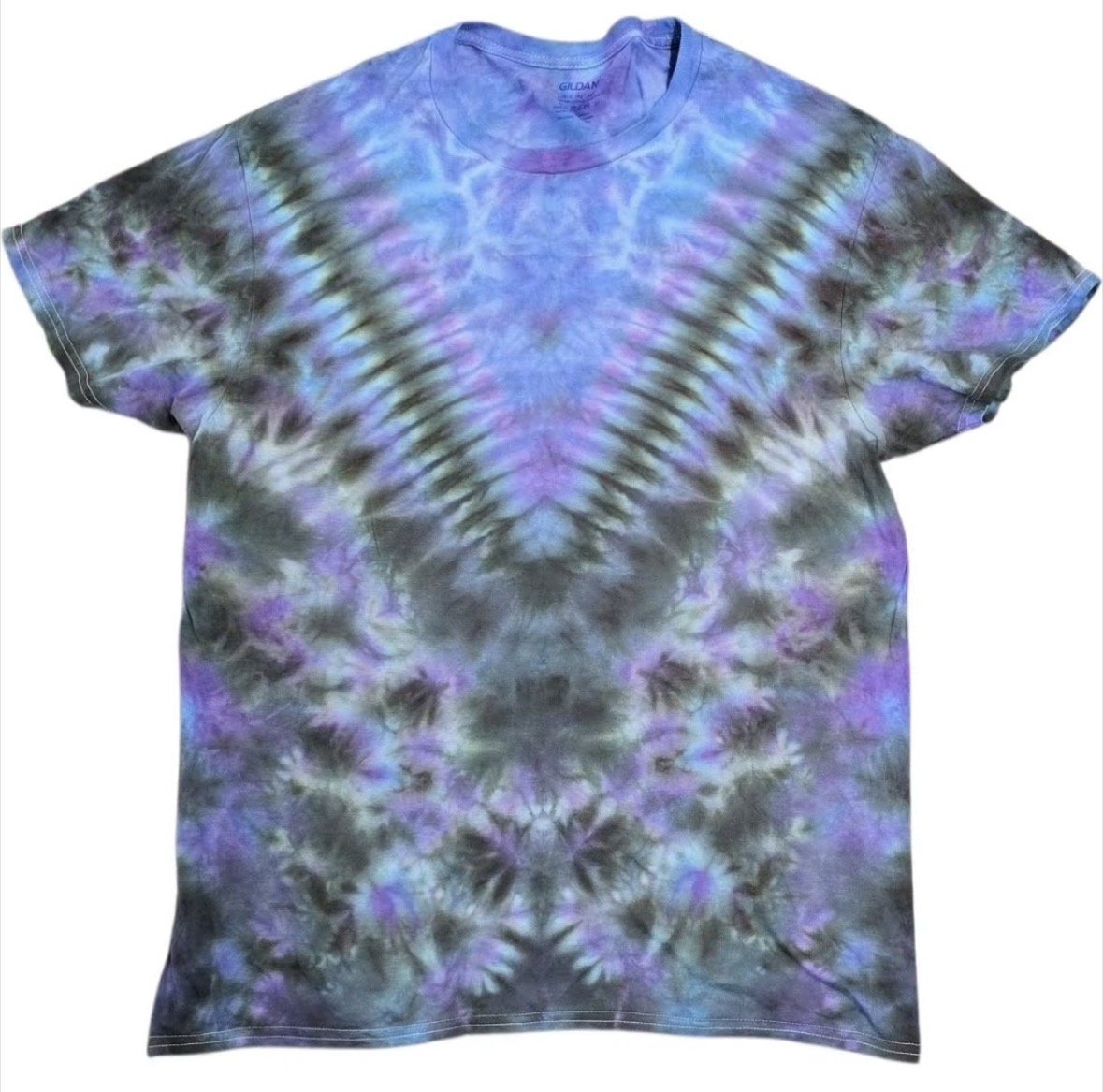 Colorful tie-dye T-shirt with purple, blue, gray, and green patterns arranged symmetrically.