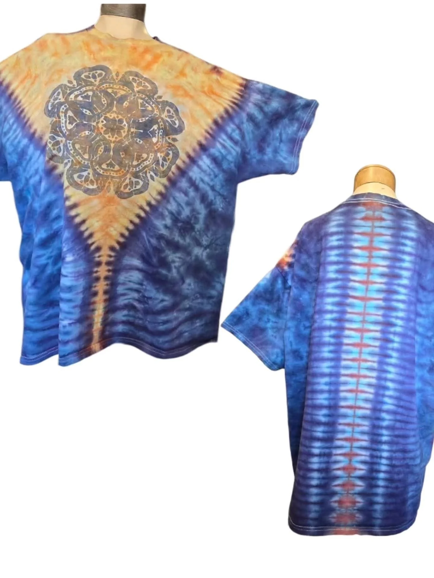 Tie-dye T-shirts with intricate circular and vertical stripe patterns in shades of blue, orange, and purple displayed on mannequins.