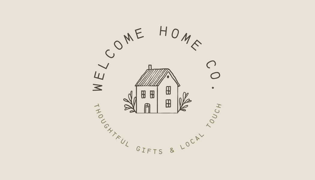 A logo with a simple drawing of a house surrounded by plants, with the text "Welcome Home Co." above and "Thoughtful Gifts & Local Touch" below in a circular arrangement, on a beige background.