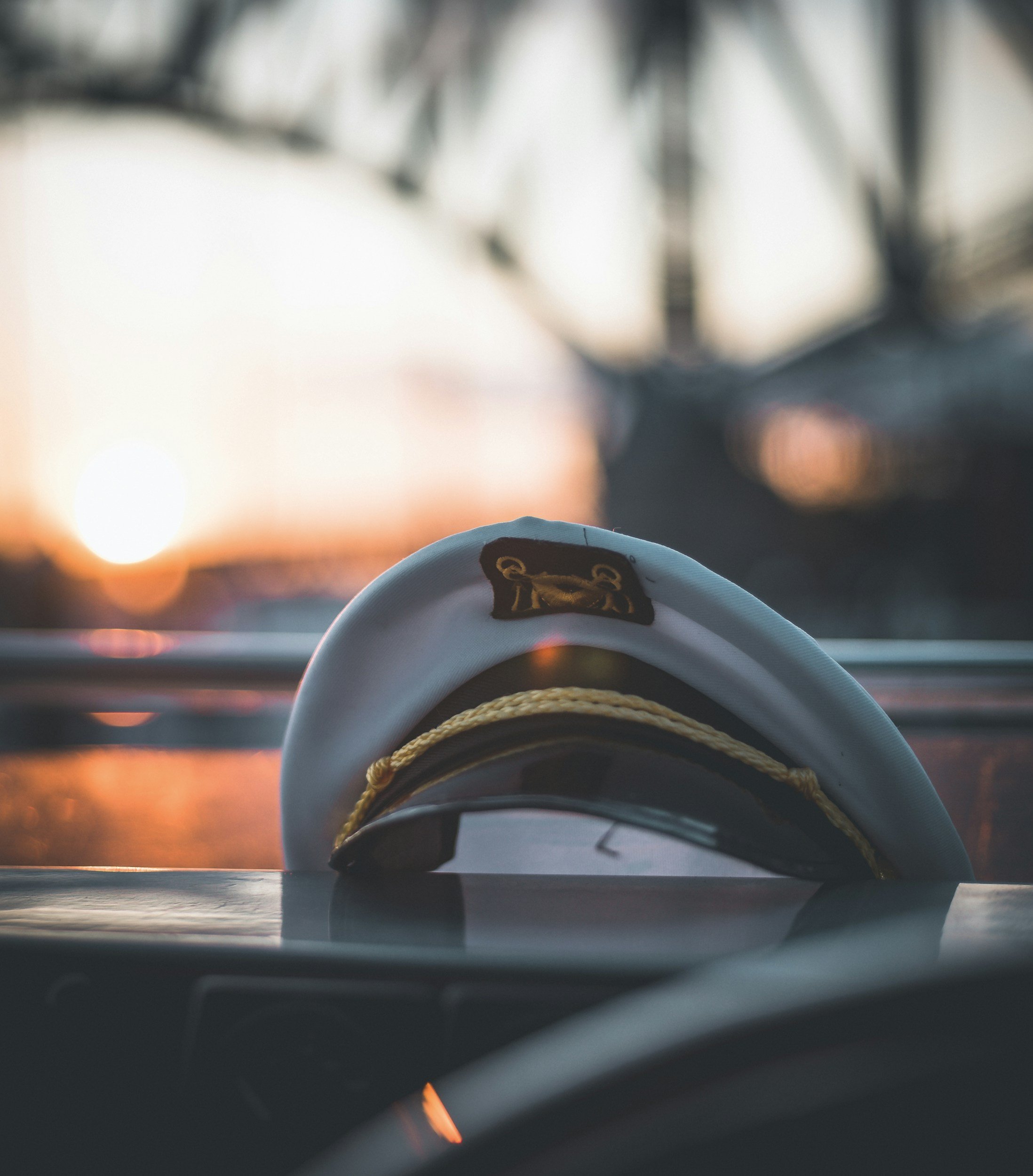 A shot of a small boat with a single person at sunset or sunrise, with the sky illuminated in warm colors and the water reflecting the sky's hues. Boat Captain for Hire
USCG Licensed Captain
Boat Delivery Captain
Yacht Delivery Captain
Captain for Hi