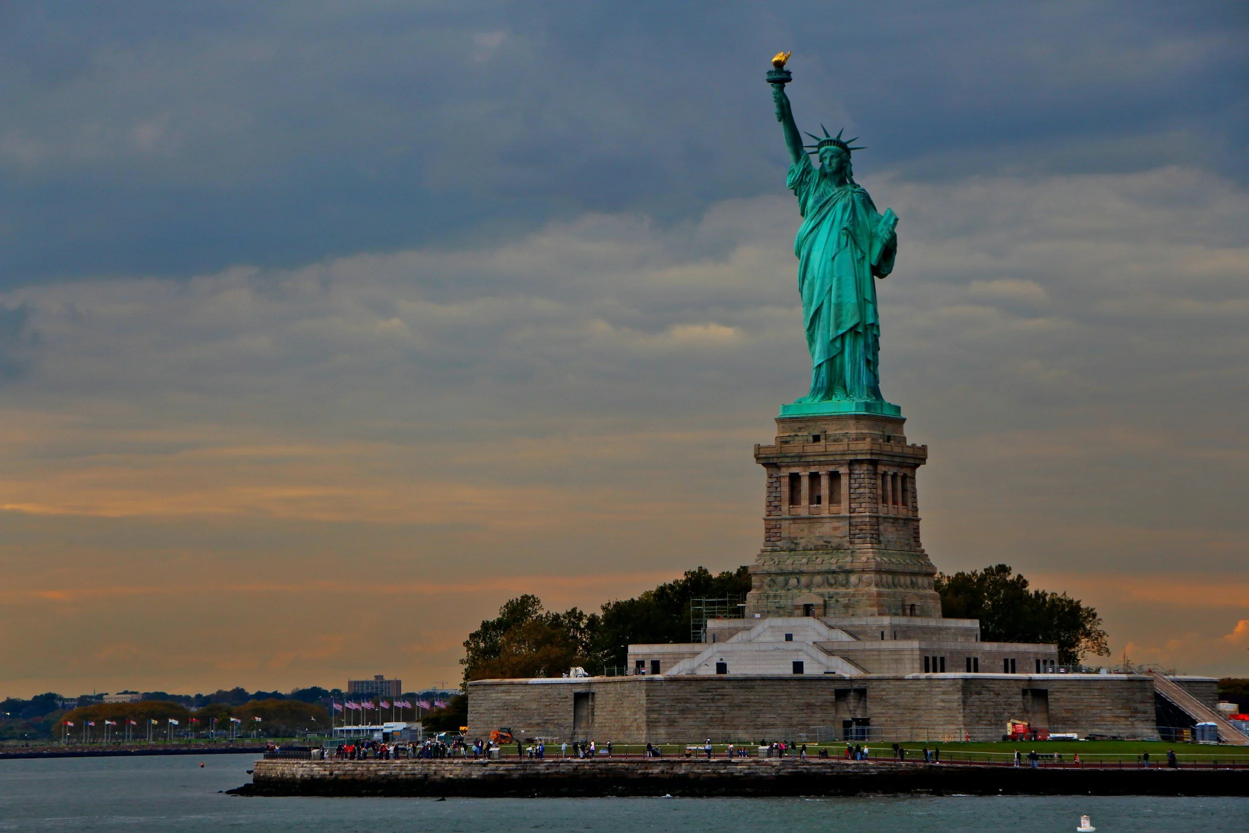 The Statue of Liberty standing tall on Liberty Island during dusk, with a cloudy sky in the background. It is surrounded by a viewing area where people are walking and gathering near the waterside. Boat Captain for Hire
USCG Licensed Captain
Boat Del