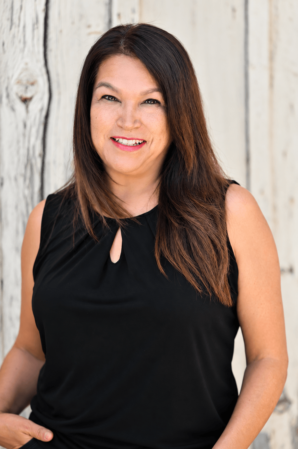 Michelle Sedillos, Administrative Assistant at Quality Builders, dressed in all black.