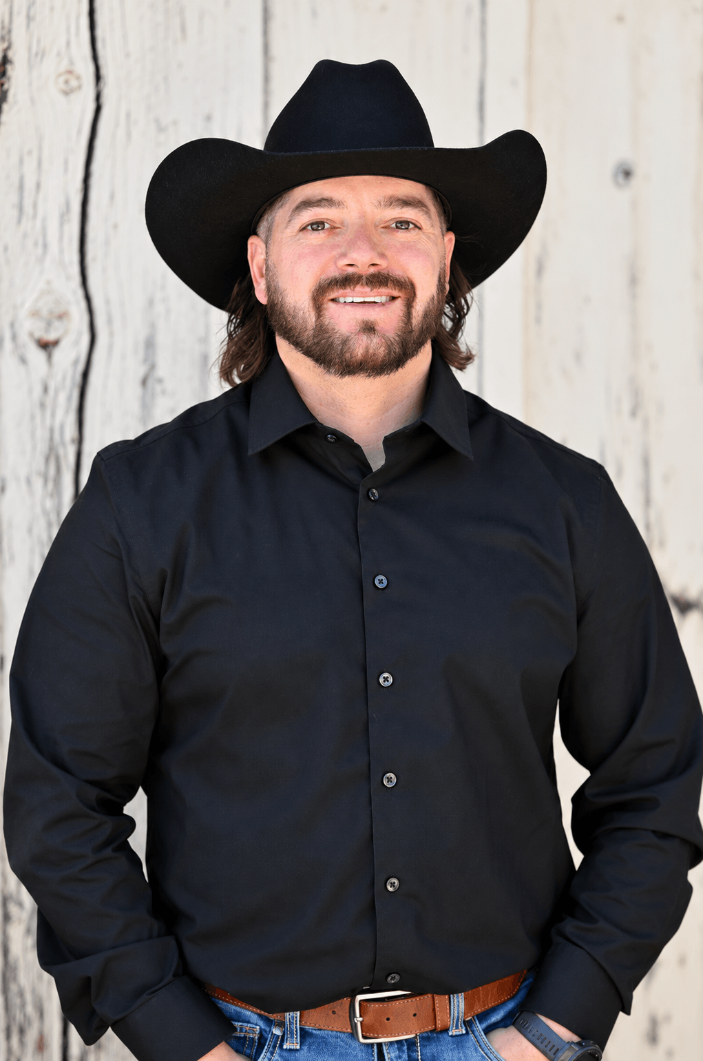 James "Mikey" Martinez, Operations Manager at Quality Builders, dressed in all black wearing a black cowboy hat.