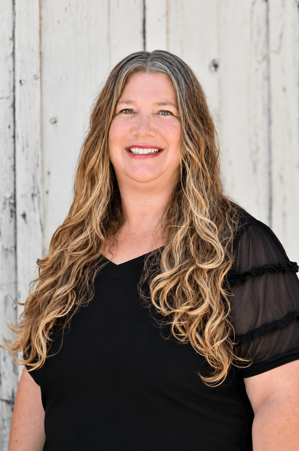 Bobbie Davis, Office Manager at Quality Builders, dressed in all black.