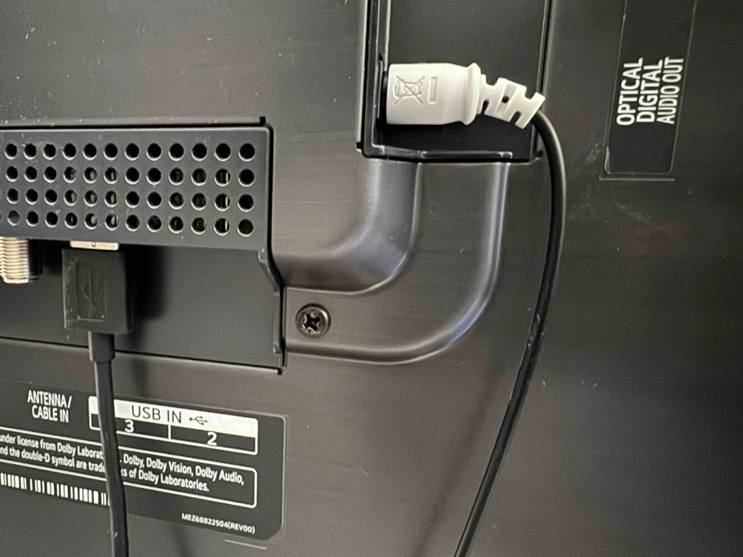 Back of an electronic device showing a power cord plugged into an outlet, with labels indicating options for antenna cable input and USB input.