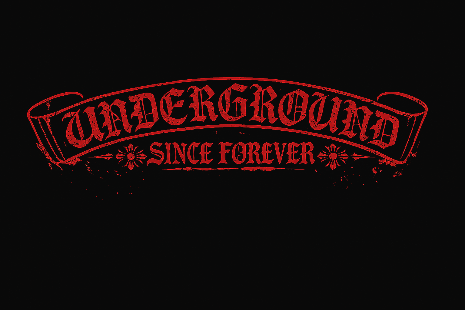 Red tattoo-style text on black background reading 'WILD & GROUND SINCE FOREVER' with decorative elements.