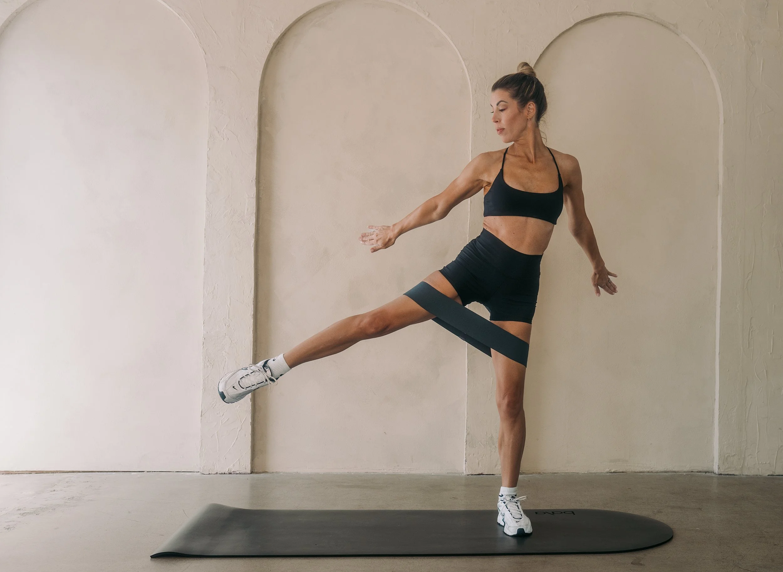 Andrea Speir mat Pilates lateral kick with looped resistance band