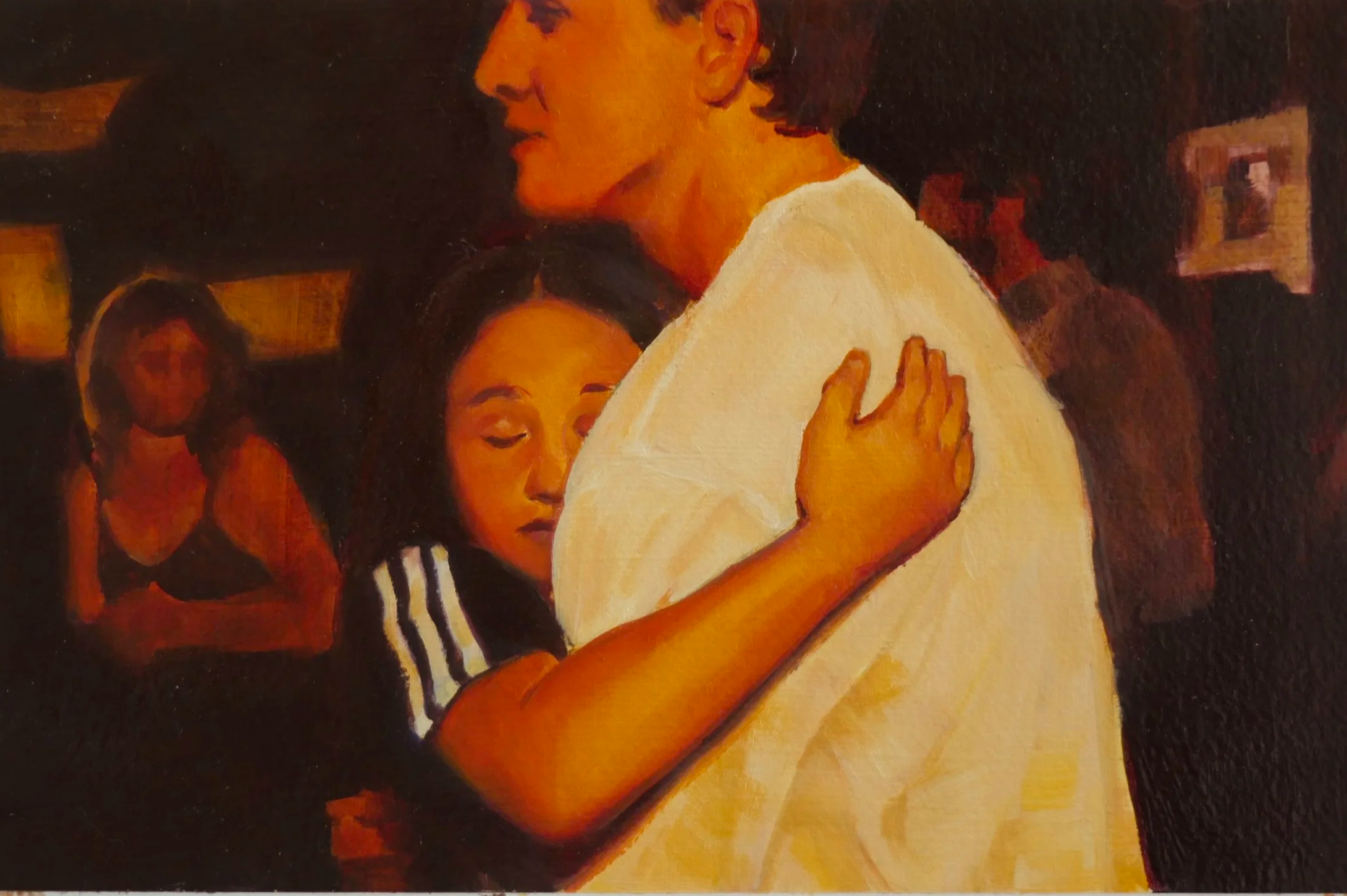 Close-up of a person with light complexion and curly hair, embracing another person with a darker complexion and long dark hair, in a party background.