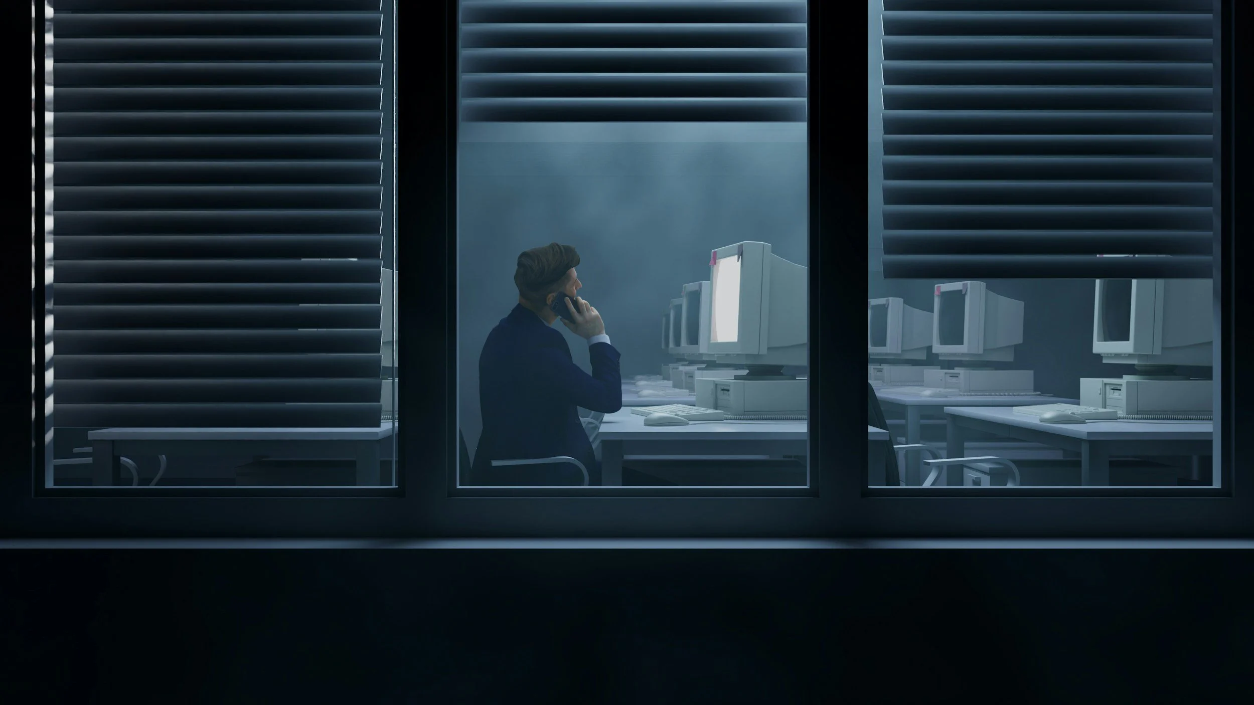 A man in a suit talking on a phone inside an office building