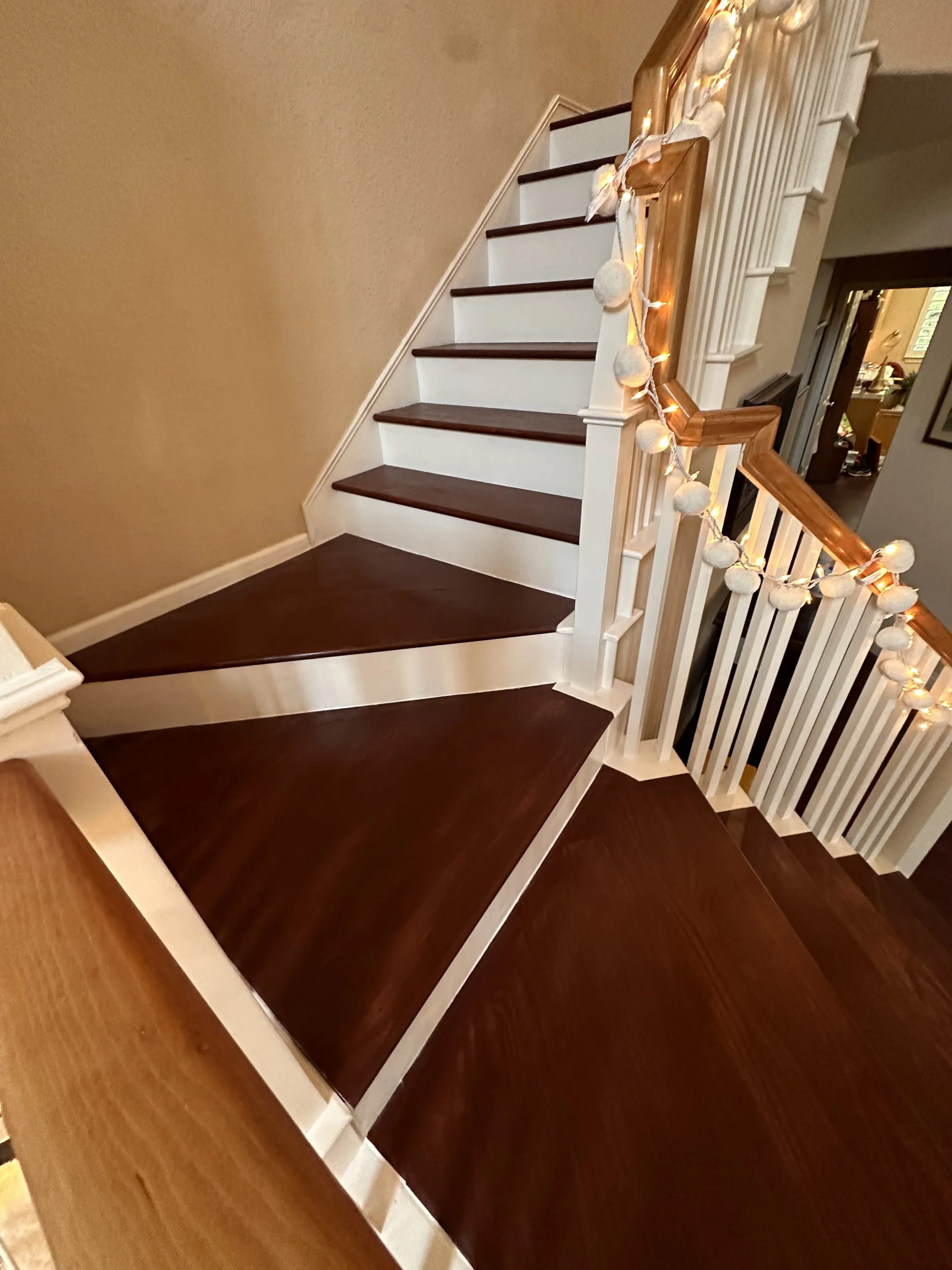 The pie-shaped landing — glued, pocket-screwed, and cut to fit the exact stairwell geometry.