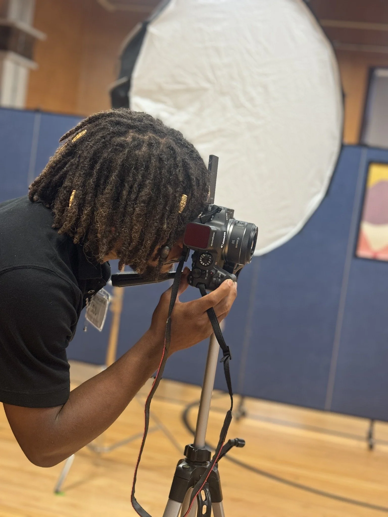 Photographer composing a portrait behind the camera.