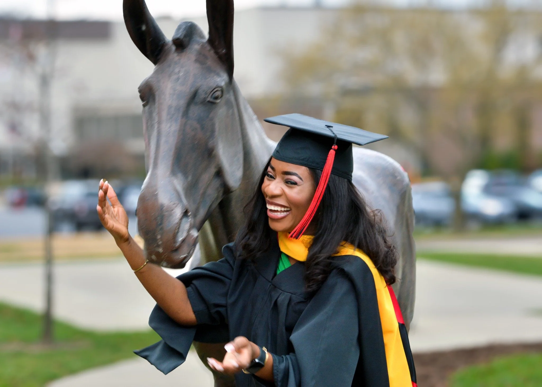A laughing graduate during an outdoor portrait session.