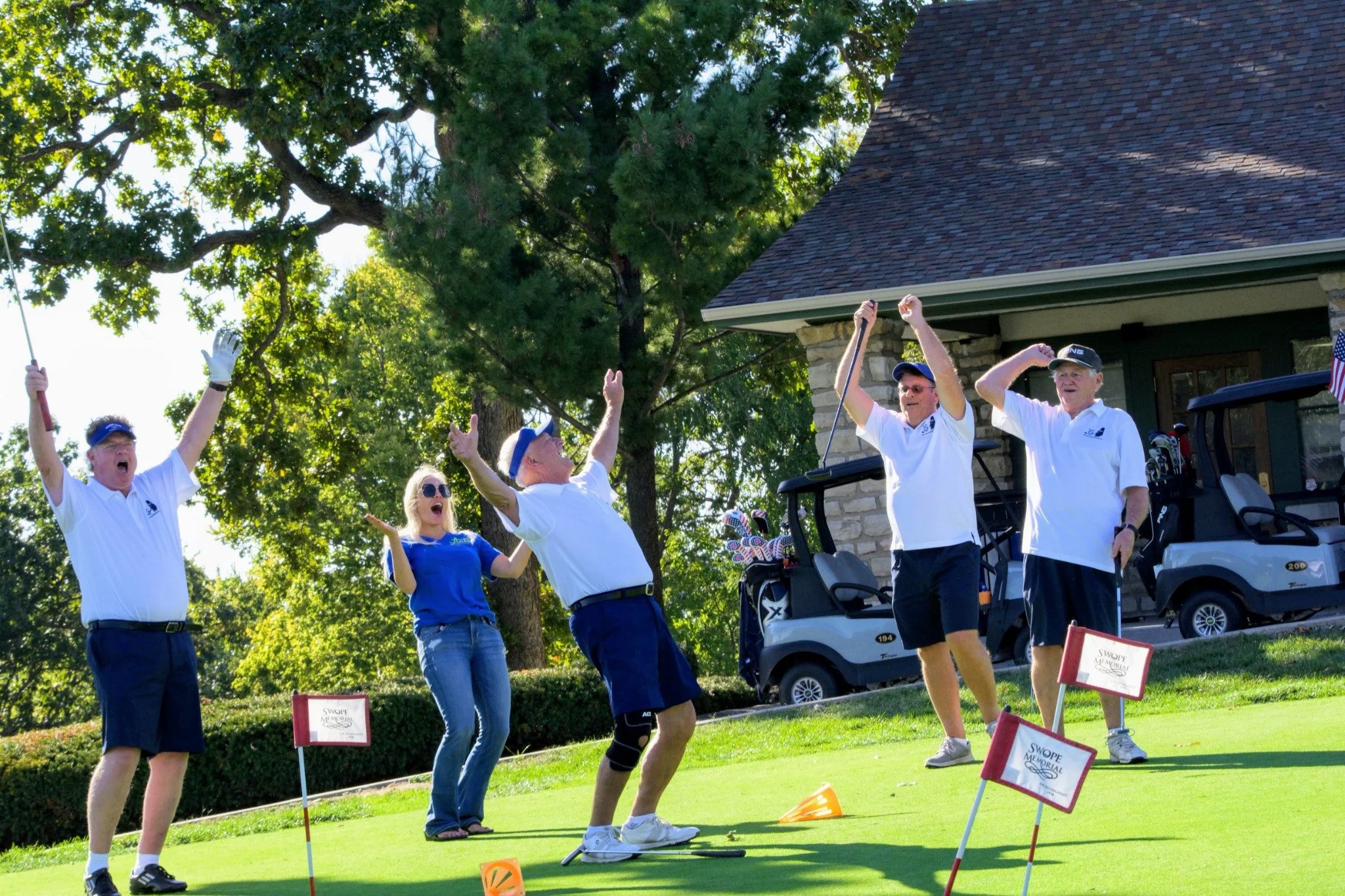 A cheering moment at the ArtsTech golf tournament.